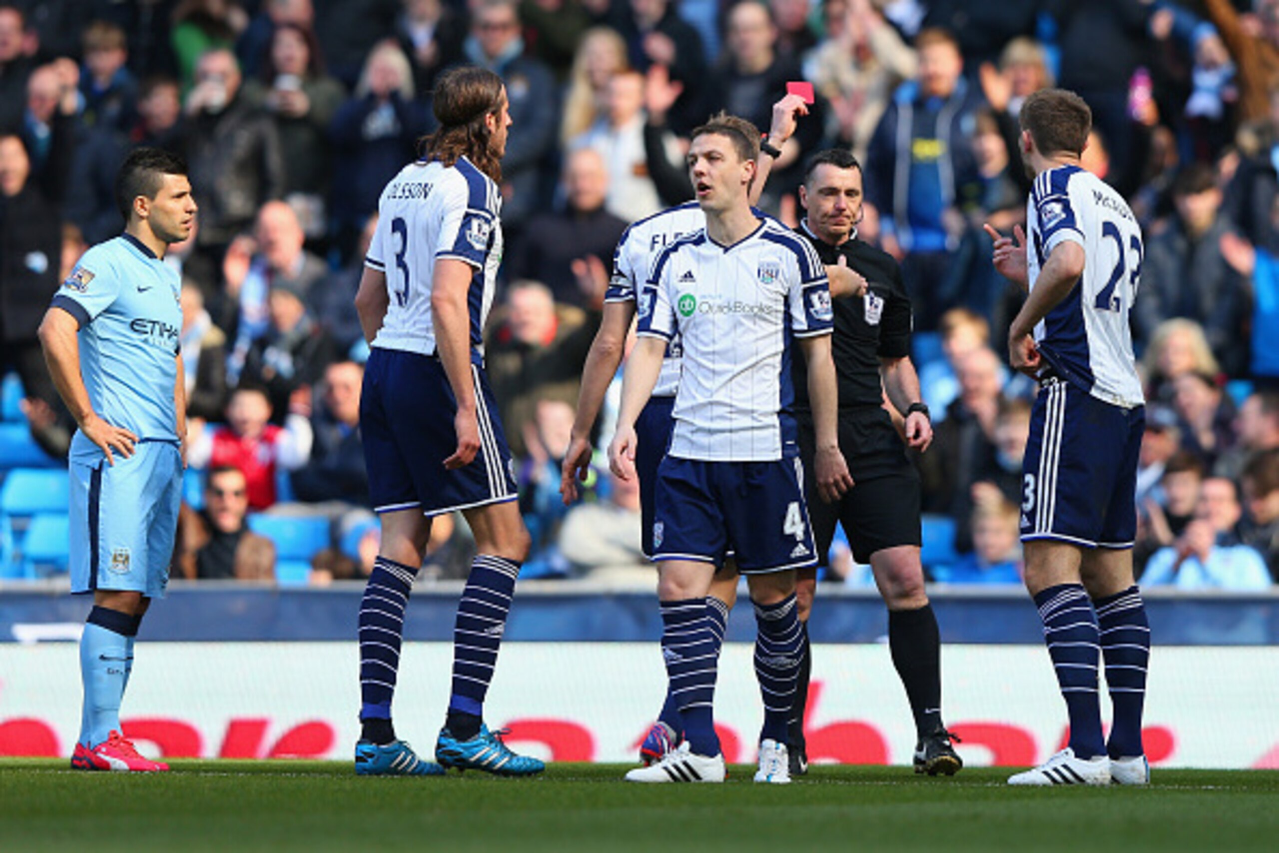 MANCHESTER, ENGLAND - MARCH 21:  Referee Neil Swarbrick shows Gareth McAuley of West Brom (R) a red card during the Barclays Premier League match between Manchester City and West Bromwich Albion at Etihad Stadium on March 21, 2015 in Manchester, England. 