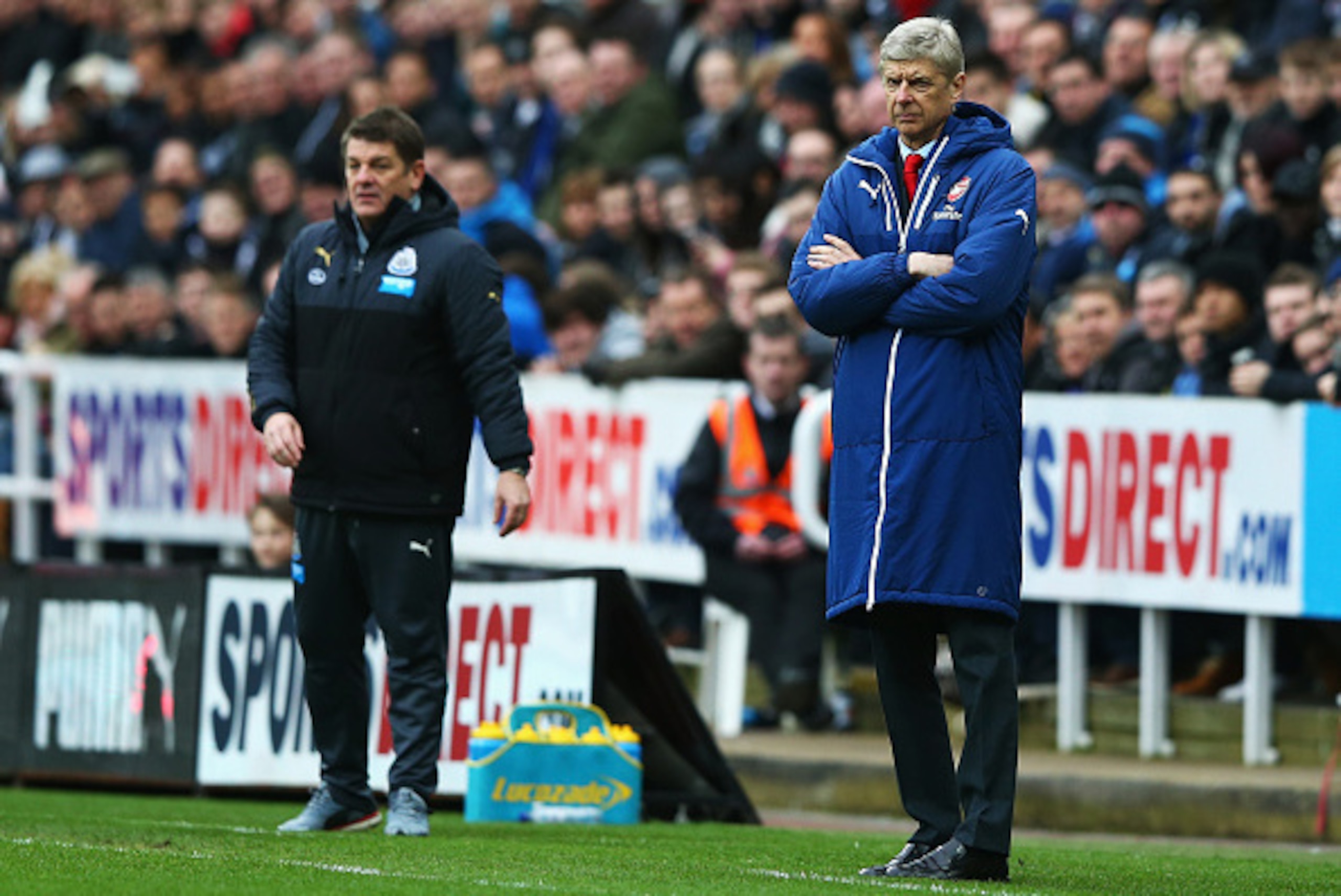 NEWCASTLE UPON TYNE, ENGLAND - MARCH 21: Arsene Wenger, manager of Arsenal looks on with John Carver, manager of Newcastle United during the Barclays Premier League match between Newcastle United and Arsenal at St James' Park on March 21, 2015 in Newcastl