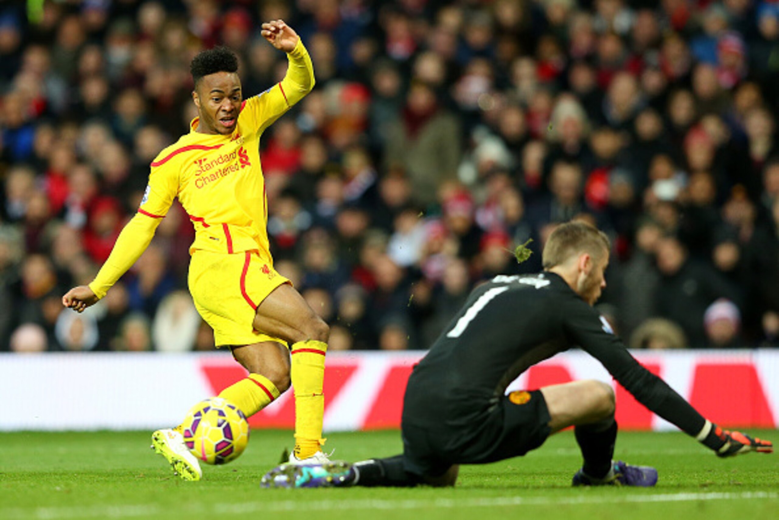 MANCHESTER, ENGLAND - DECEMBER 14:  Dvid De Gea of Manchester United saves the attempt on goal of Raheem Sterling of Liverpool in a one on one situation during the Barclays Premier League match between Manchester United and Liverpool at Old Trafford on De