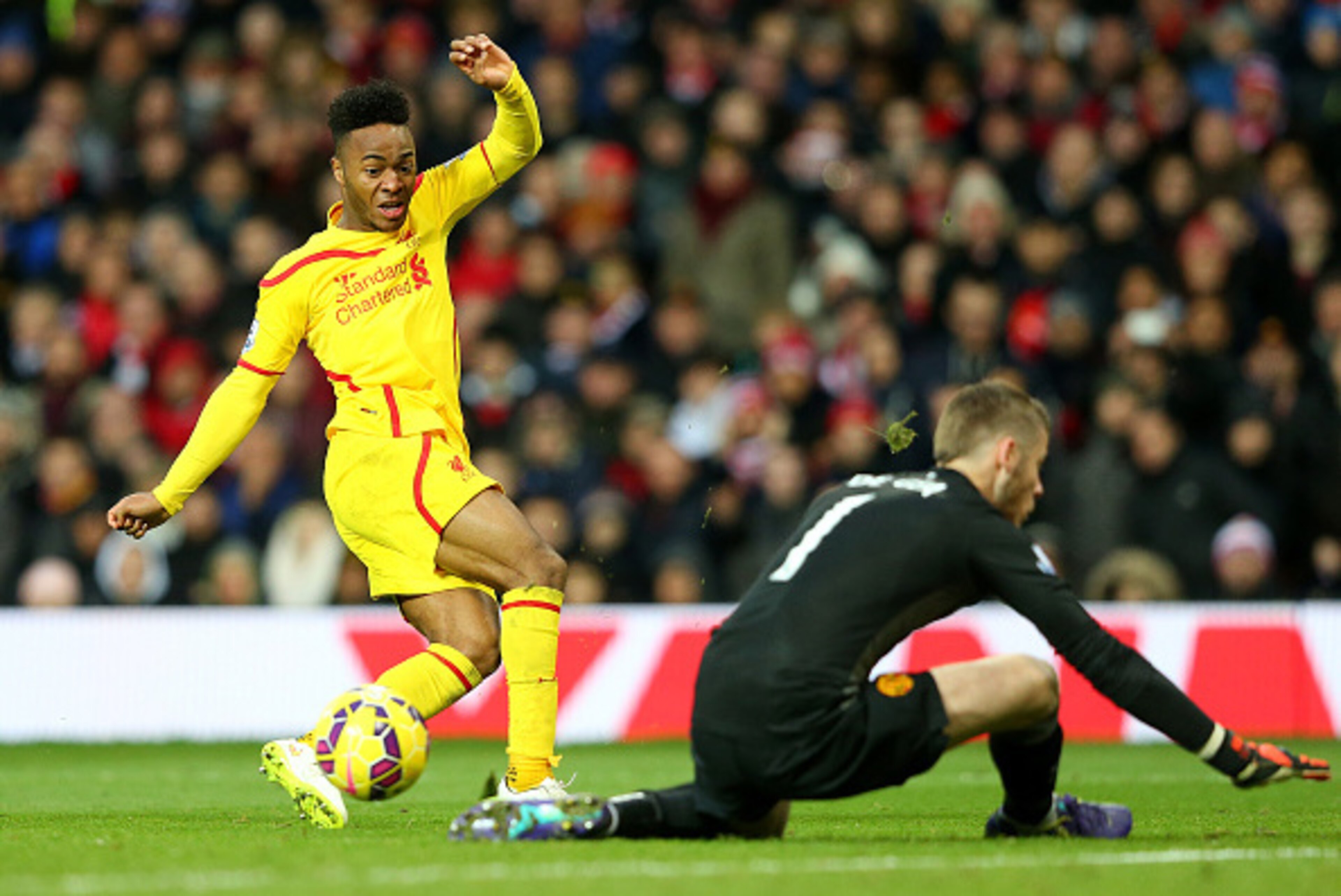 MANCHESTER, ENGLAND - DECEMBER 14:  Dvid De Gea of Manchester United saves the attempt on goal of Raheem Sterling of Liverpool in a one on one situation during the Barclays Premier League match between Manchester United and Liverpool at Old Trafford on De