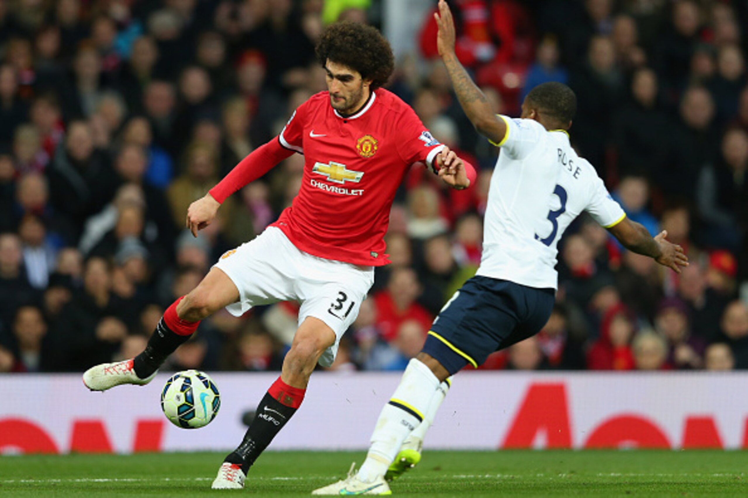 MANCHESTER, ENGLAND - MARCH 15:  Marouane Fellaini of Manchester United turns Danny Rose of Tottenham Hotspur during the Barclays Premier League match between Manchester United and Tottenham Hotspur at Old Trafford on March 15, 2015 in Manchester, England