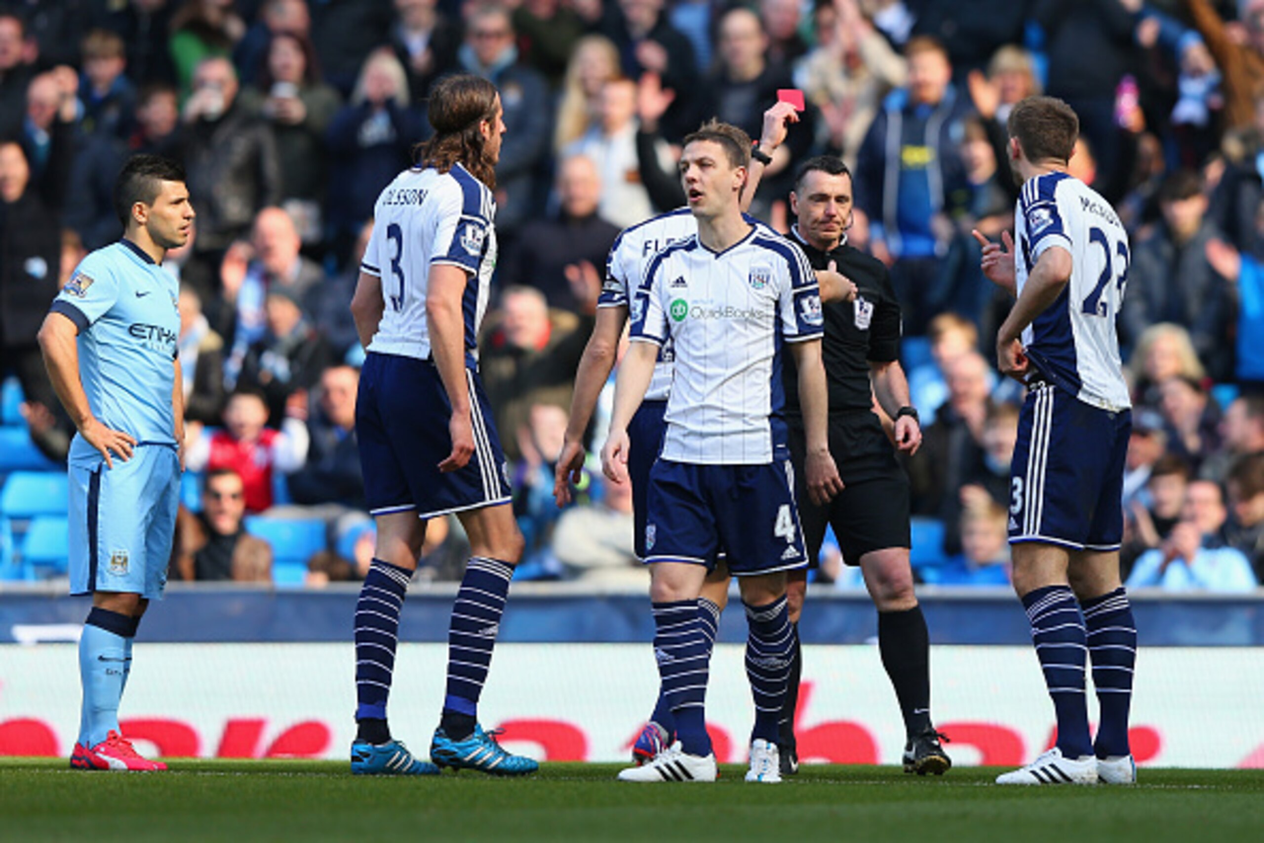 MANCHESTER, ENGLAND - MARCH 21:  Referee Neil Swarbrick shows Gareth McAuley of West Brom (R) a red card during the Barclays Premier League match between Manchester City and West Bromwich Albion at Etihad Stadium on March 21, 2015 in Manchester, England. 