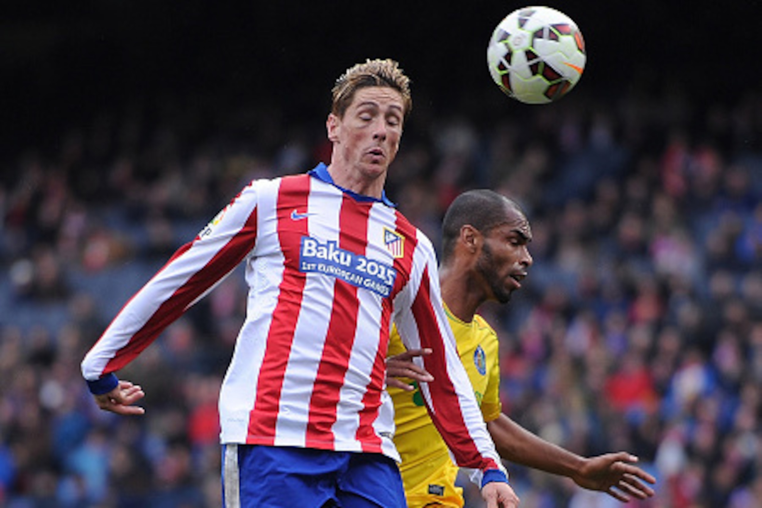 MADRID, SPAIN - MARCH 21:  Fernando Torres of Club Atletico de Madrid heads the ball beside Edinaldo Gomes 'Naldo' of Getafe CF during the La Liga match between Club Atletico de Madrid and Getafe CF at Vicente Calderon Stadium on March 21, 2015 in Madrid,
