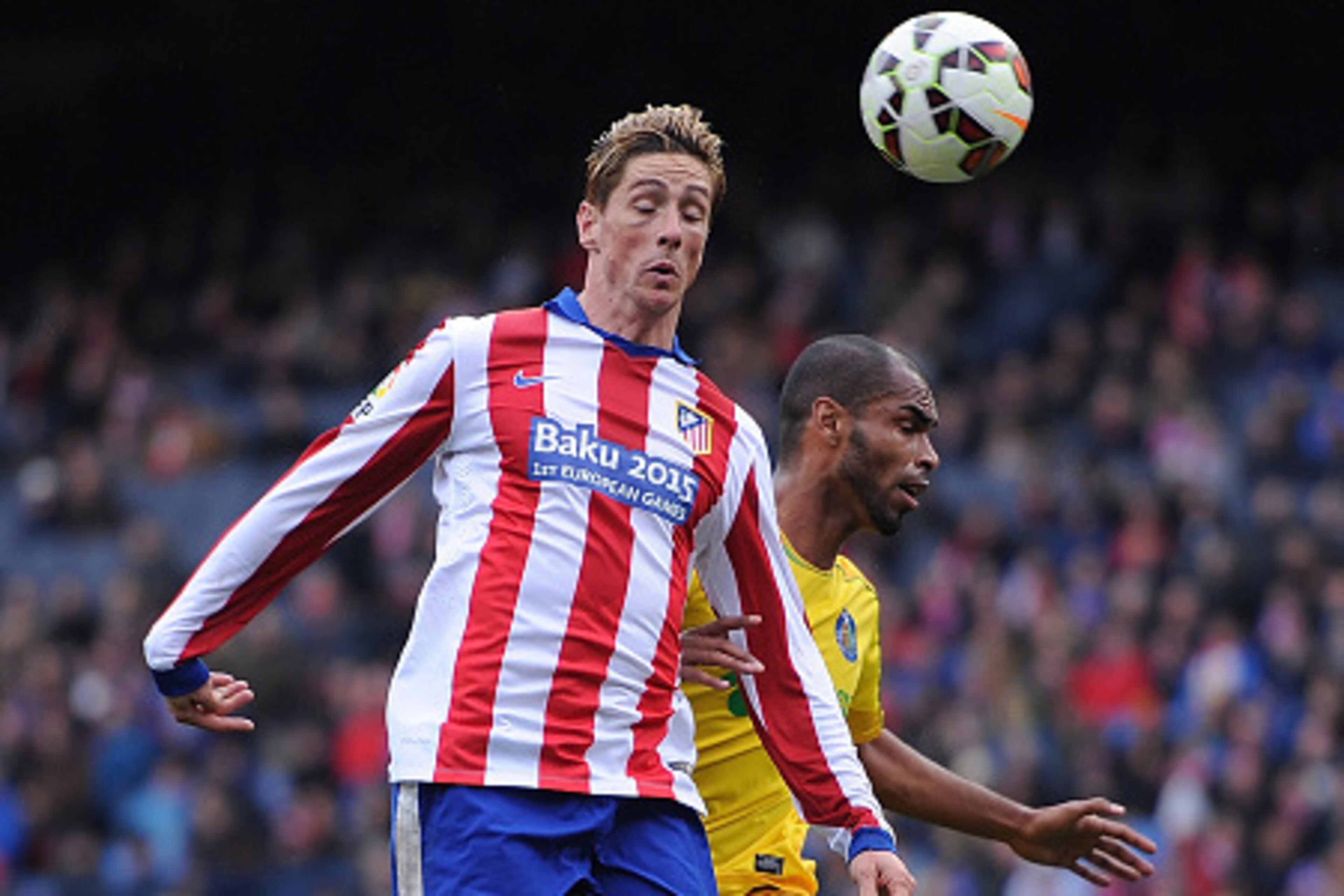 MADRID, SPAIN - MARCH 21:  Fernando Torres of Club Atletico de Madrid heads the ball beside Edinaldo Gomes 'Naldo' of Getafe CF during the La Liga match between Club Atletico de Madrid and Getafe CF at Vicente Calderon Stadium on March 21, 2015 in Madrid,