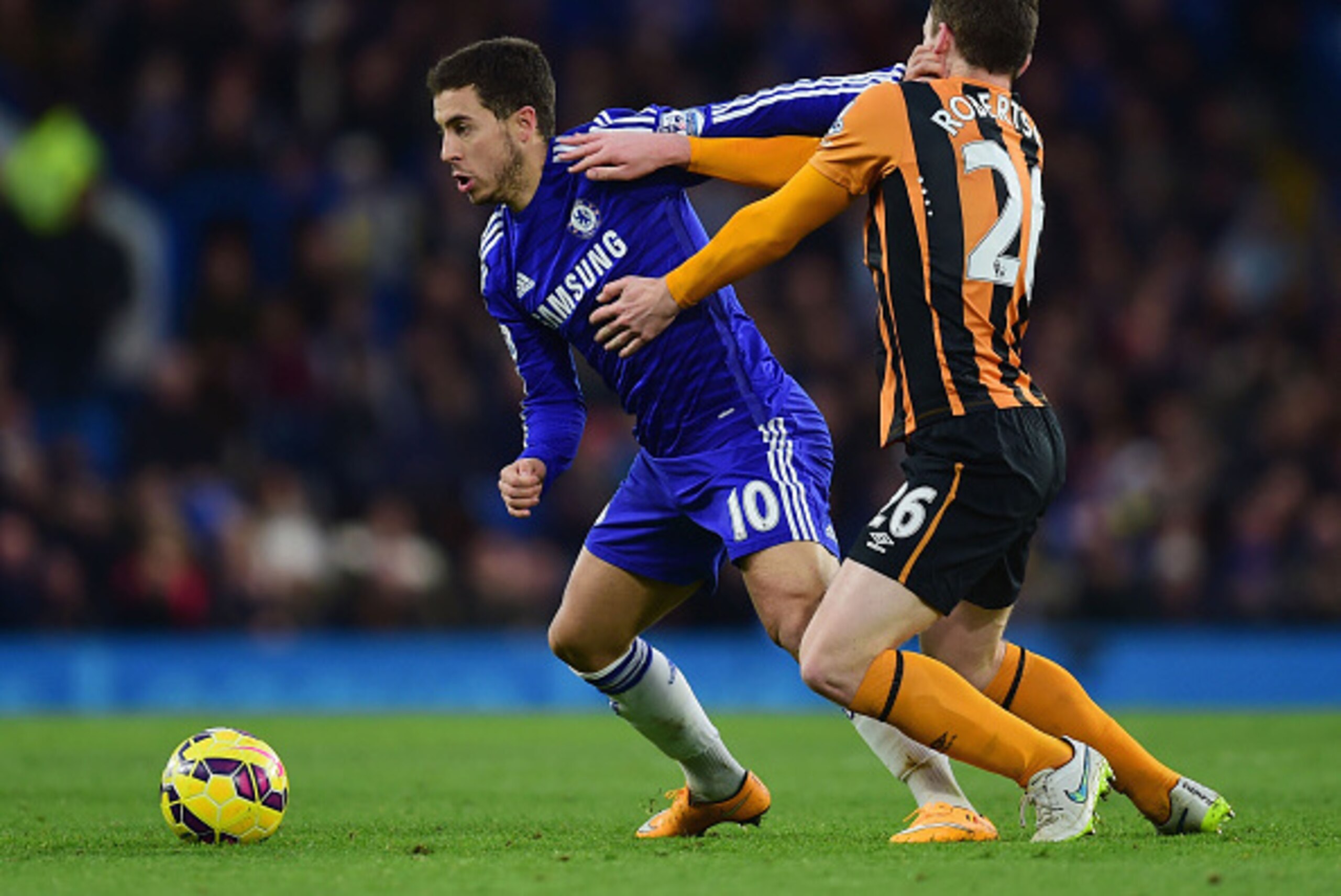 LONDON, ENGLAND - DECEMBER 13:  Eden Hazard of Chelsea holds off Andrew Robertson of Hull City during the Barclays Premier League match between Chelsea and Hull City at Stamford Bridge on December 13, 2014 in London, England.  (Photo by Jamie McDonald/Get