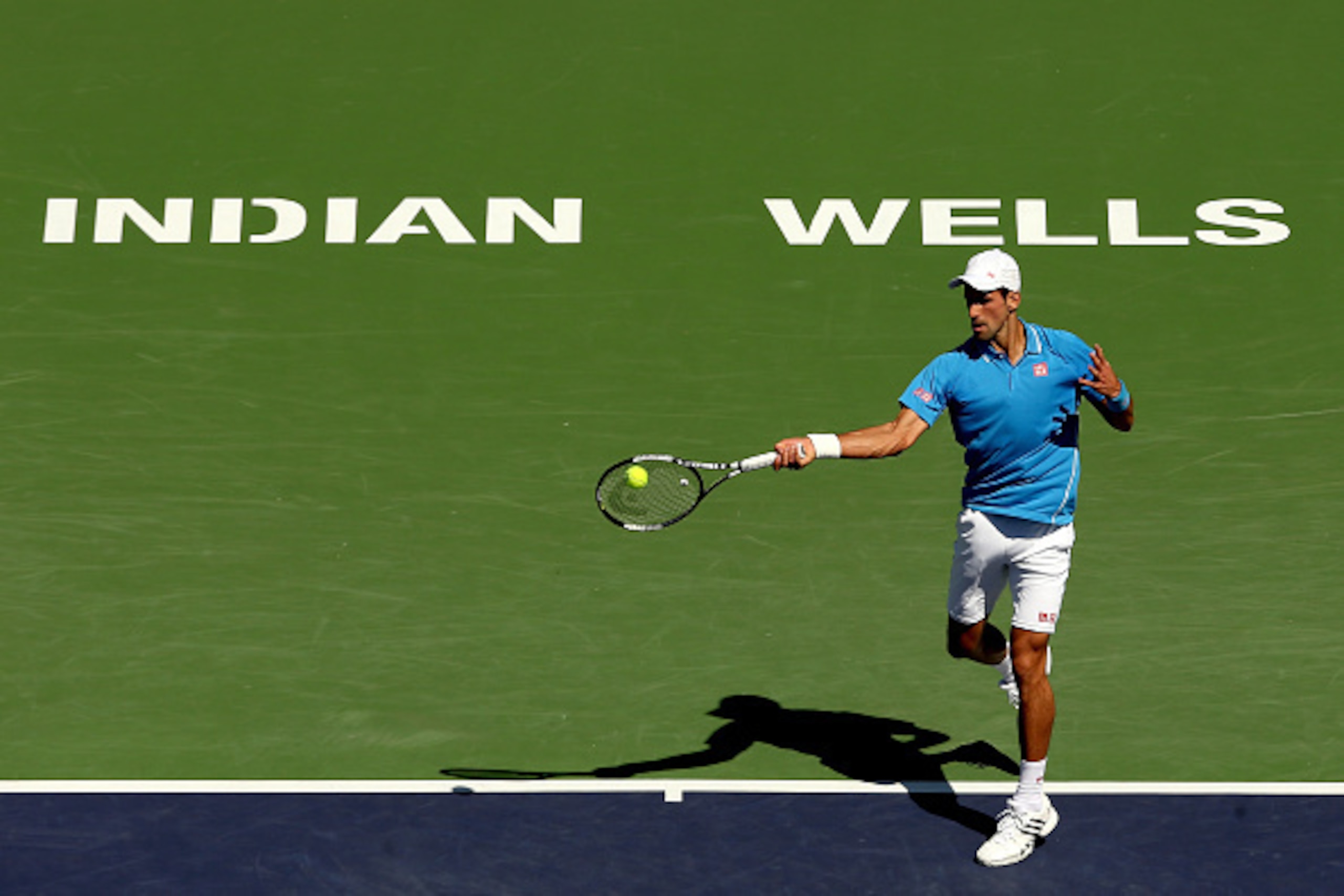 INDIAN WELLS, CA - MARCH 21:  Novak Djokovic of Serbia returns a shot to Andy Murray of Great Britain during semifinals on day thirteen of the BNP Paribas Open at the Indian Wells Tennis Garden on March 21, 2015 in Indian Wells, California.  (Photo by Mat