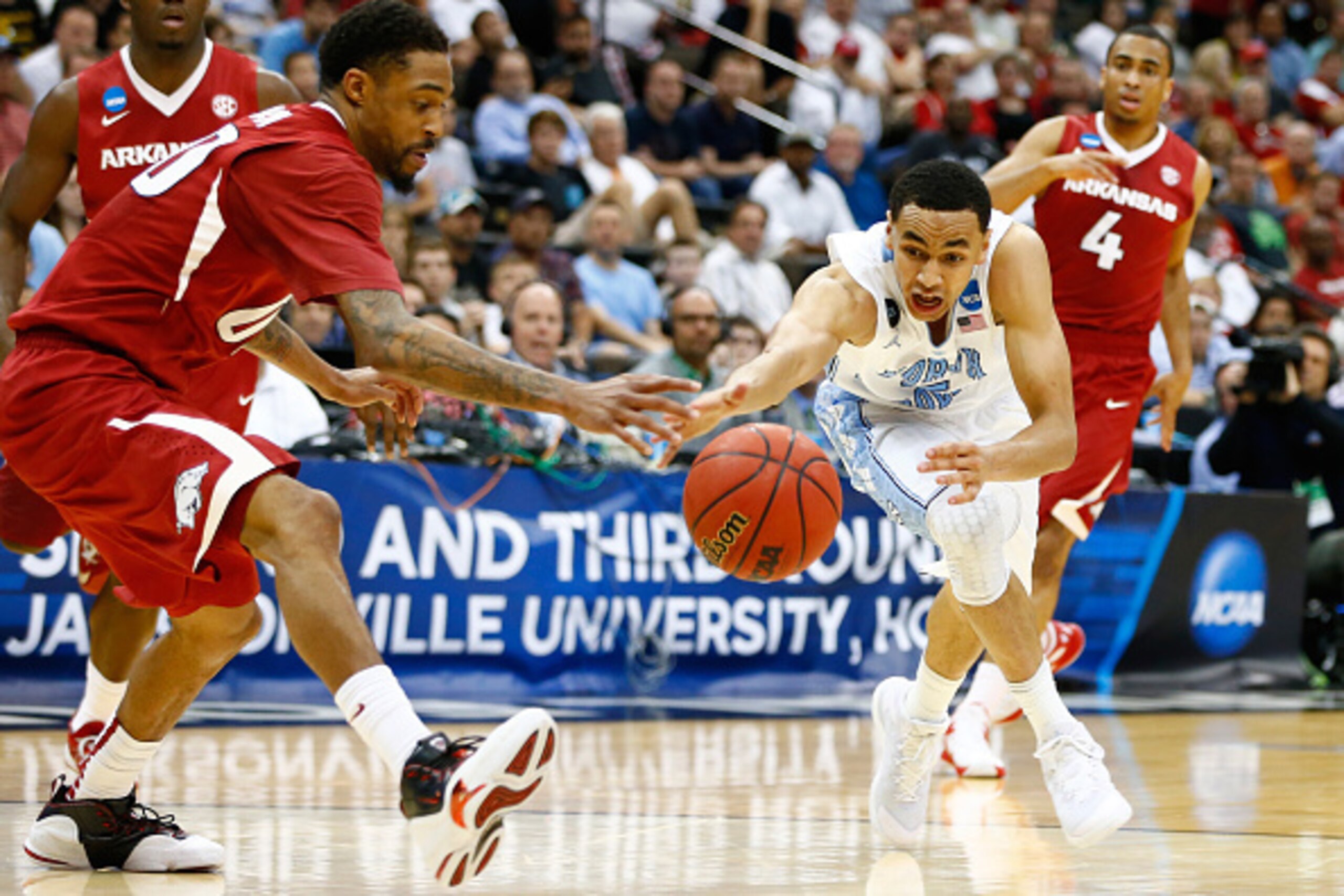 JACKSONVILLE, FL - MARCH 21: Marcus Paige #5 of the North Carolina Tar Heels dribbles by Rashad Madden #00 of the Arkansas Razorbacks in the second half during the third round of the 2015 NCAA Men's Basketball Tournament at Jacksonville Veterans Memorial JACKSONVILLE, FL - MARCH 21: Marcus Paige #5 of the North Carolina Tar Heels dribbles by Rashad Madden #00 of the Arkansas Razorbacks in the second half during the third round of the 2015 NCAA Men's Basketball Tournament at Jacksonville Veterans Memorial