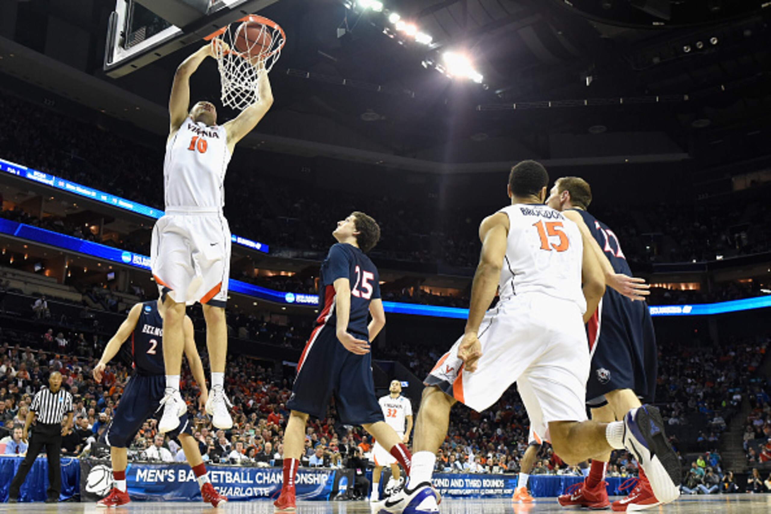 CHARLOTTE, NC - MARCH 20:  Mike Tobey #10 of the Virginia Cavaliers dunks the ball against the Belmont Bruins during the second round of the 2015 NCAA Men's Basketball Tournament at Time Warner Cable Arena on March 20, 2015 in Charlotte, North Carolina.  