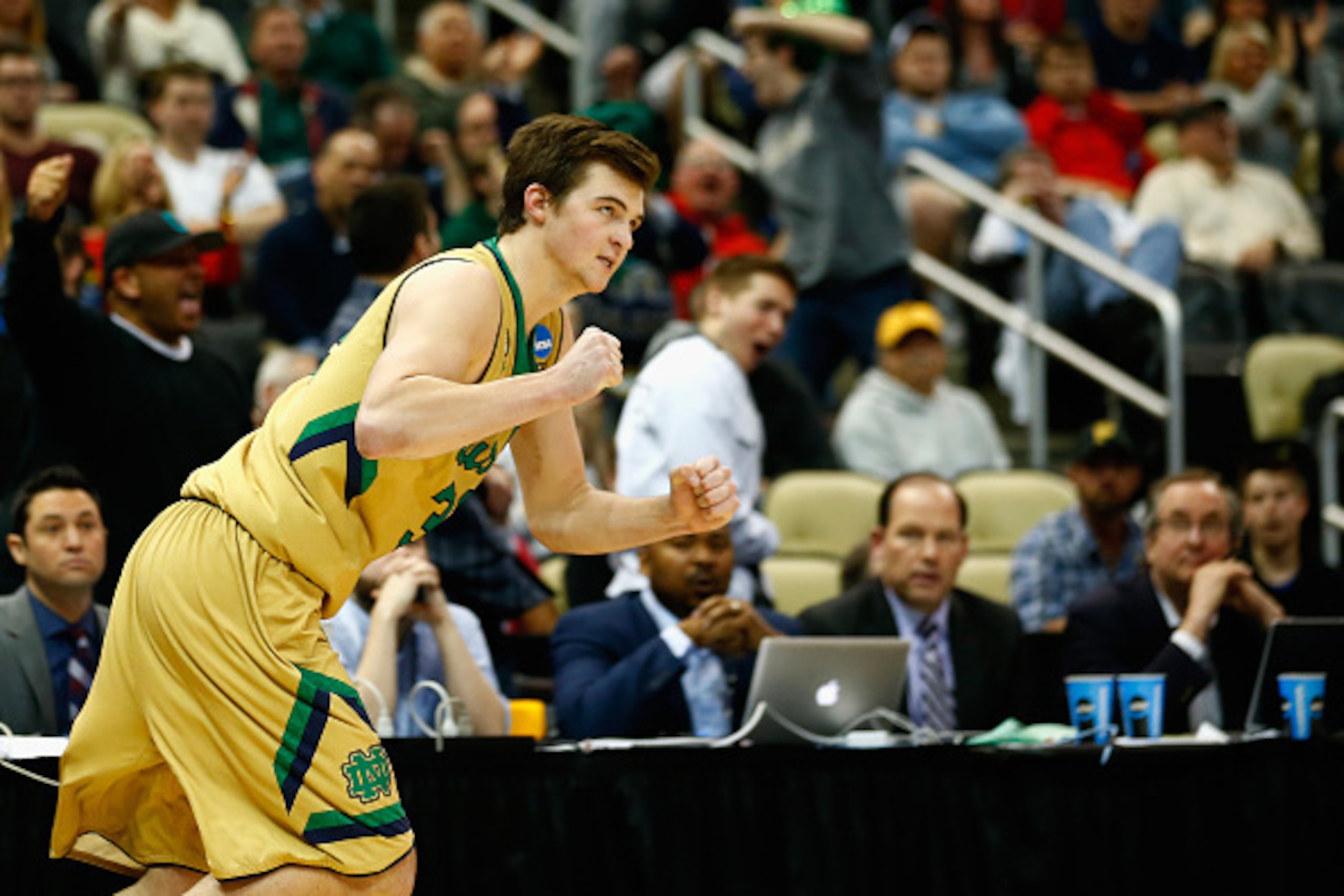 PITTSBURGH, PA - MARCH 21:  Steve Vasturia #32 of the Notre Dame Fighting Irish celebrates after sinking a three pointer against the Butler Bulldogs in overtime during the third round of the 2015 NCAA Men's Basketball Tournament at Consol Energy Center on