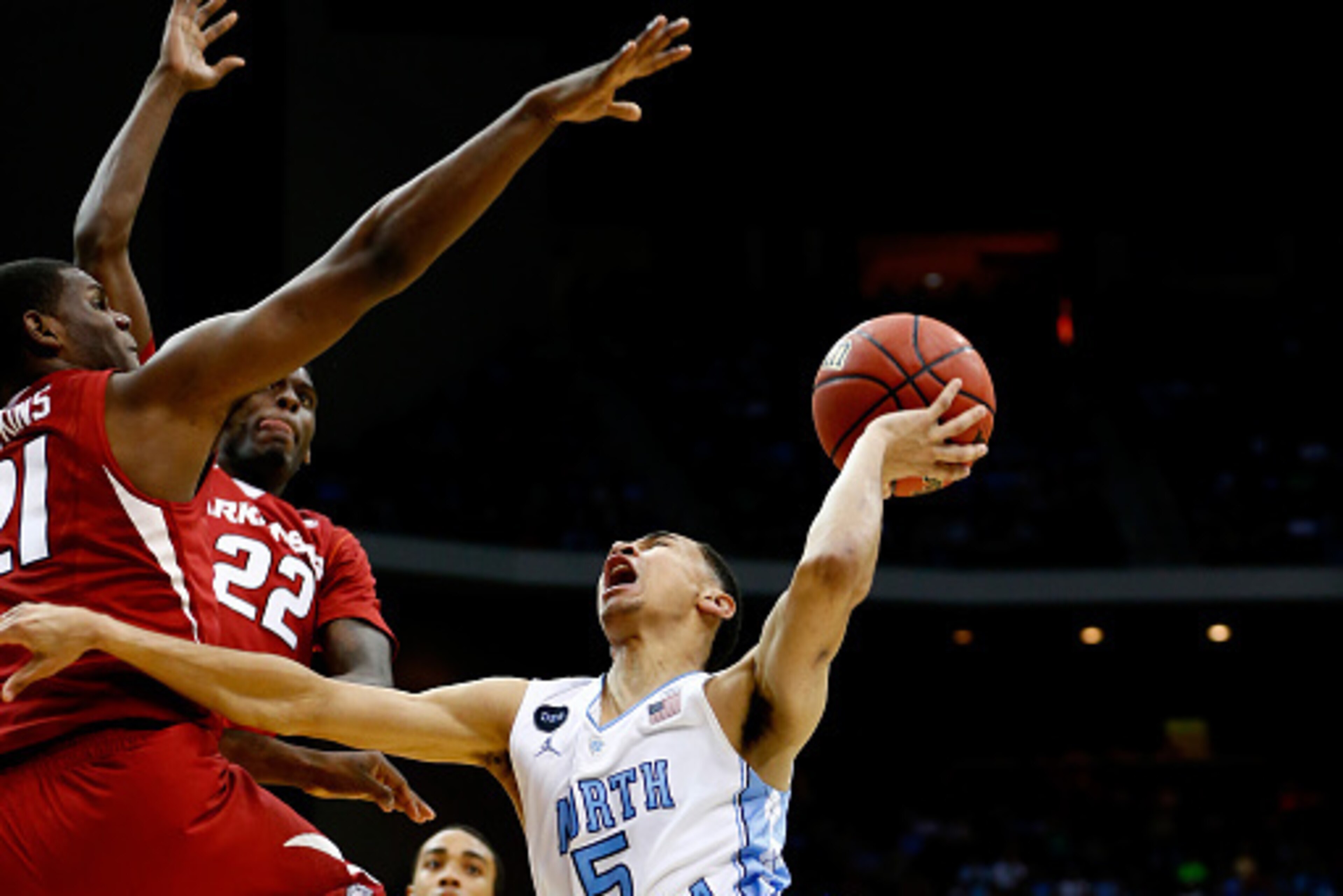 JACKSONVILLE, FL - MARCH 21:  Marcus Paige #5 of the North Carolina Tar Heels puts up a shot as he is defended by Manuale Watkins #21 of the Arkansas Razorbacks in the second half during the third round of the 2015 NCAA Men's Basketball Tournament at Jack