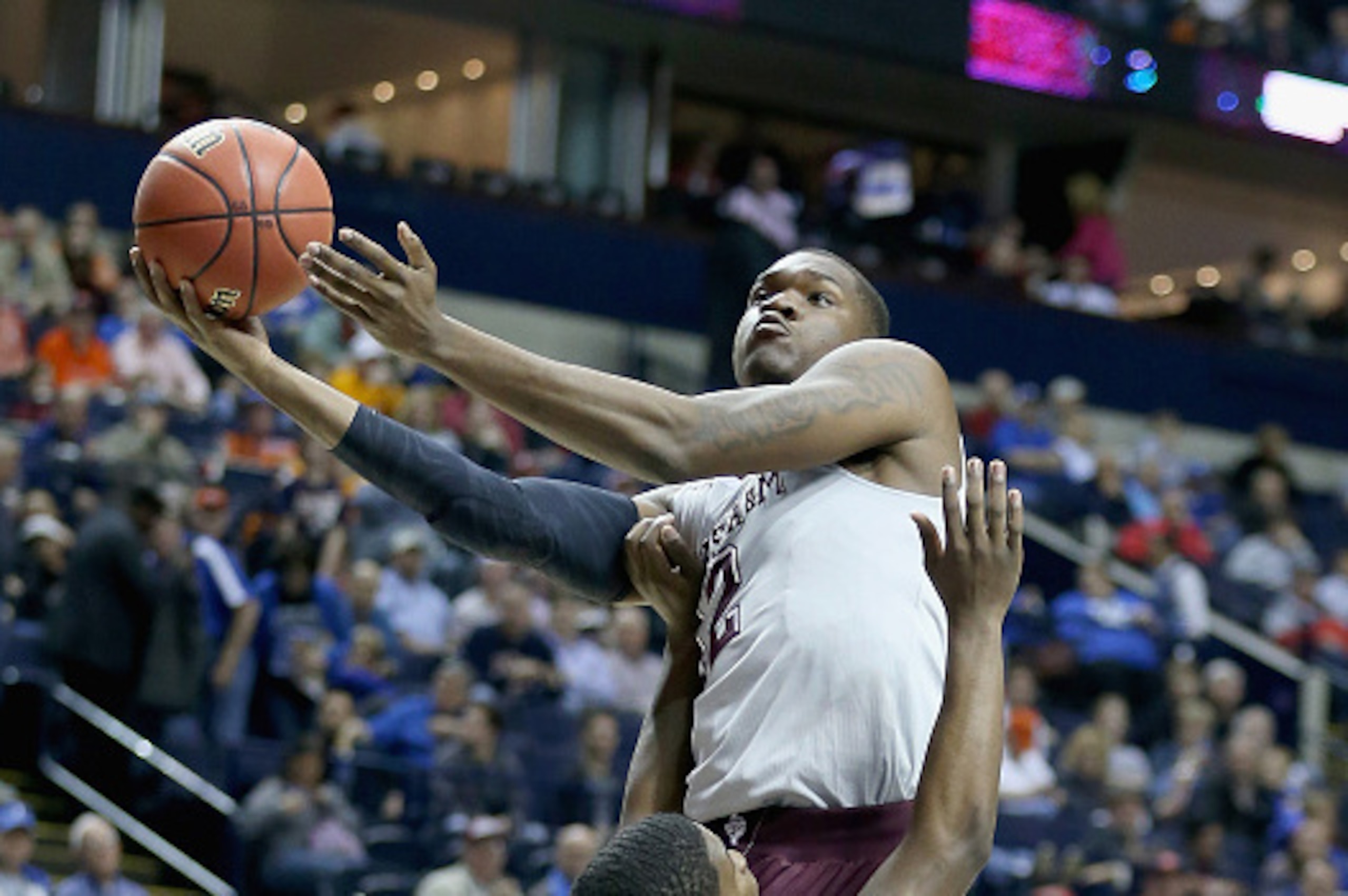 NASHVILLE, TN - MARCH 12:  Jalen Jones #12 of the Texas A&M Aggies shoots the ball against the Auburn Tigers during the second round game of the SEC Basketball Tournament at Bridgestone Arena on March 12, 2015 in Nashville, Tennessee.  (Photo by Andy Lyon
