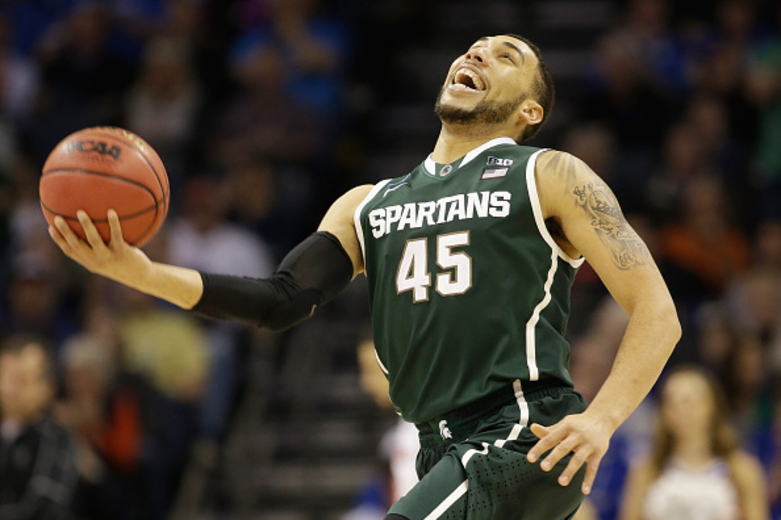 CHARLOTTE, NC - MARCH 22:  Denzel Valentine #45 of the Michigan State Spartans reacts after defeating the Michigan State Spartans 60-54 during the third round of the 2015 NCAA Men's Basketball Tournament at Time Warner Cable Arena on March 22, 2015 in Cha
