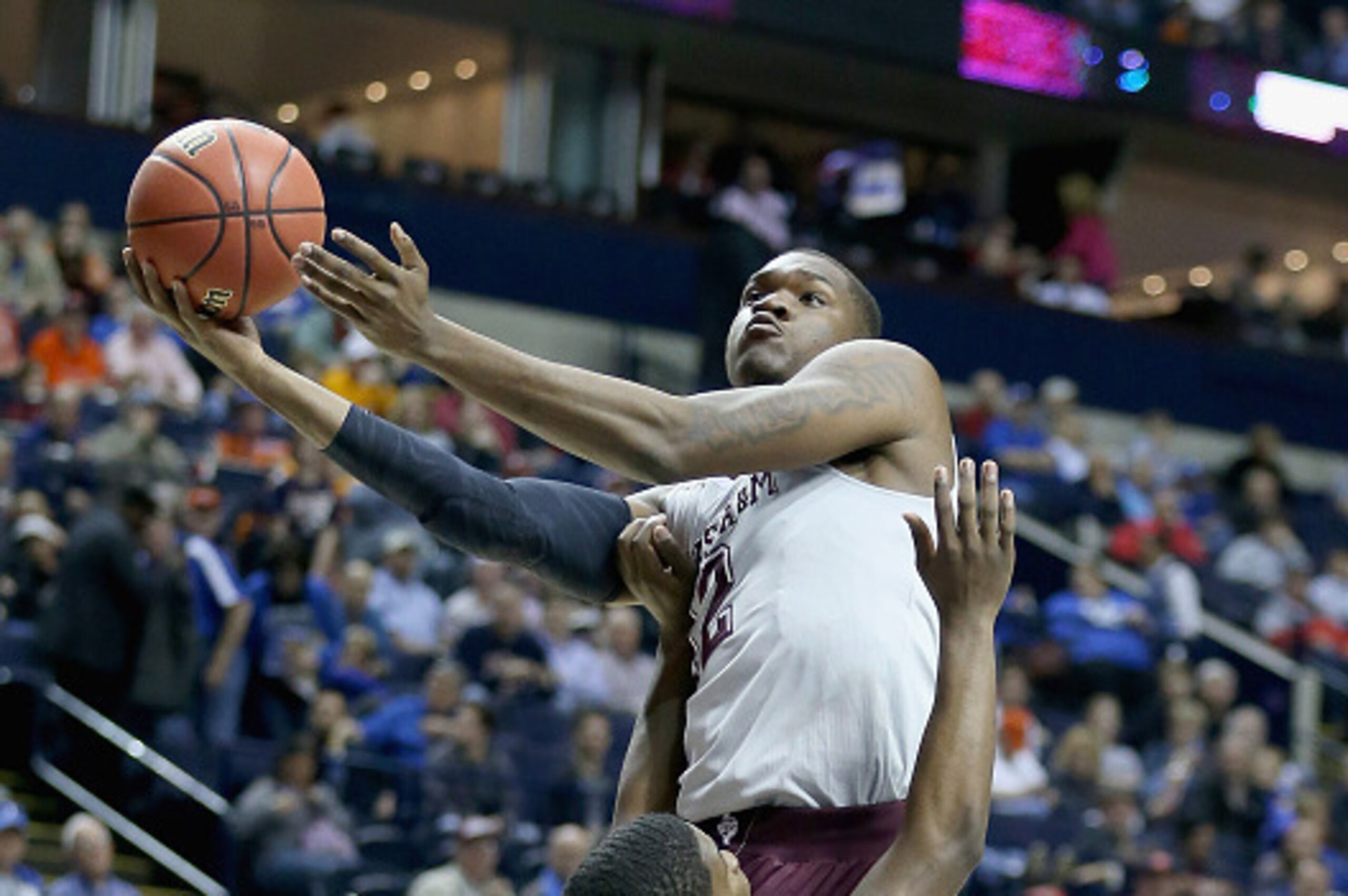 NASHVILLE, TN - MARCH 12:  Jalen Jones #12 of the Texas A&M Aggies shoots the ball against the Auburn Tigers during the second round game of the SEC Basketball Tournament at Bridgestone Arena on March 12, 2015 in Nashville, Tennessee.  (Photo by Andy Lyon
