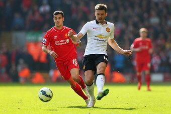 LIVERPOOL, ENGLAND - MARCH 22: Michael Carrick of Manchester United is closed down by Philippe Coutinho of Liverpool during the Barclays Premier League match between Liverpool and Manchester United at Anfield on March 22, 2015 in Liverpool, England.  (Pho