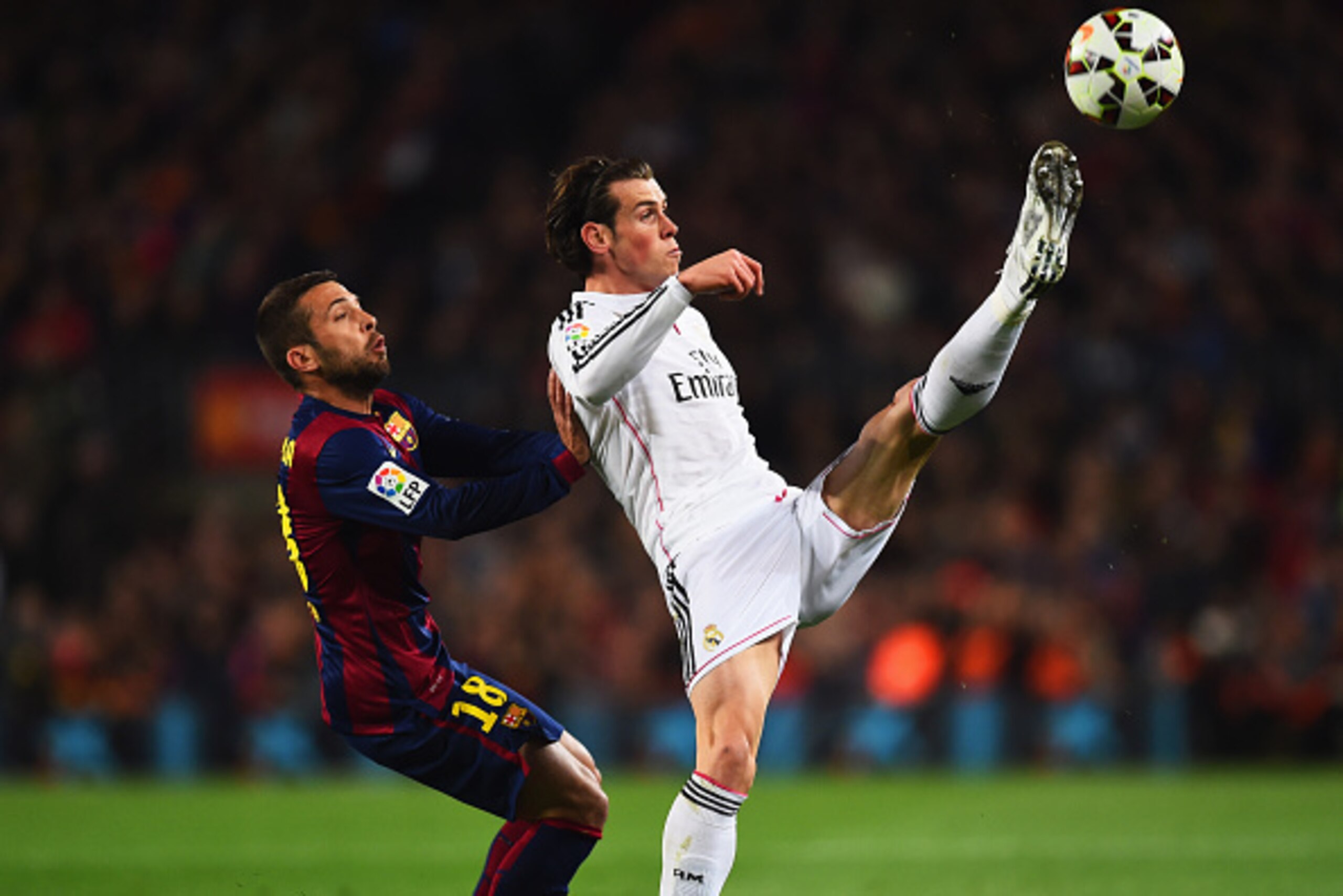 BARCELONA, SPAIN - MARCH 22:  Gareth Bale of Real Madrid CF stretches for the ball ahead of Jordi Alba of Barcelona during the La Liga match between FC Barcelona and Real Madrid CF at Camp Nou on March 22, 2015 in Barcelona, Spain.  (Photo by Alex Caparro