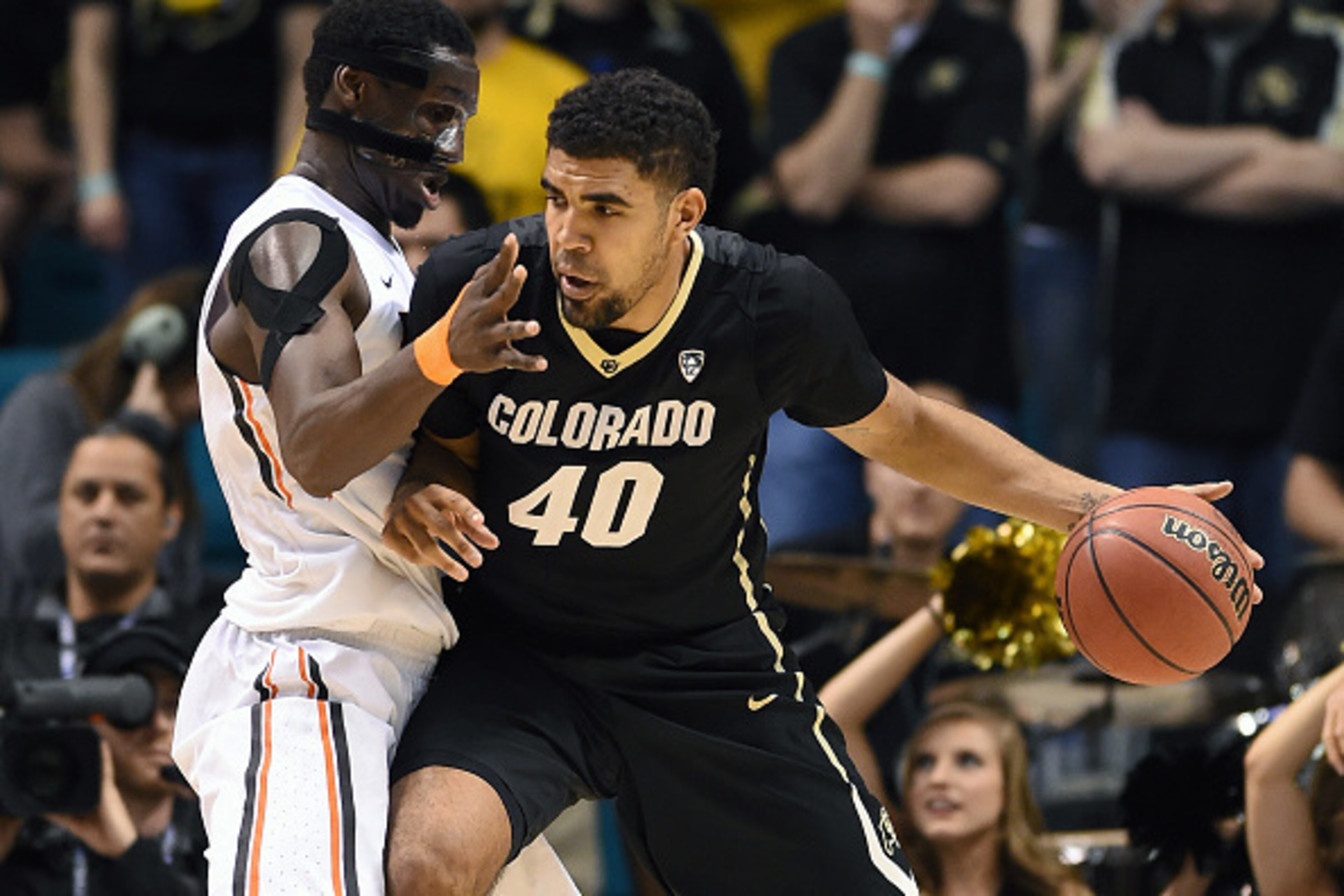 LAS VEGAS, NV - MARCH 11:  Josh Scott #40 of the Colorado Buffaloes is guarded by Daniel Gomis #14 of the Oregon State Beavers during a first-round game of the Pac-12 Basketball Tournament at the MGM Grand Garden Arena on March 11, 2015 in Las Vegas, Neva