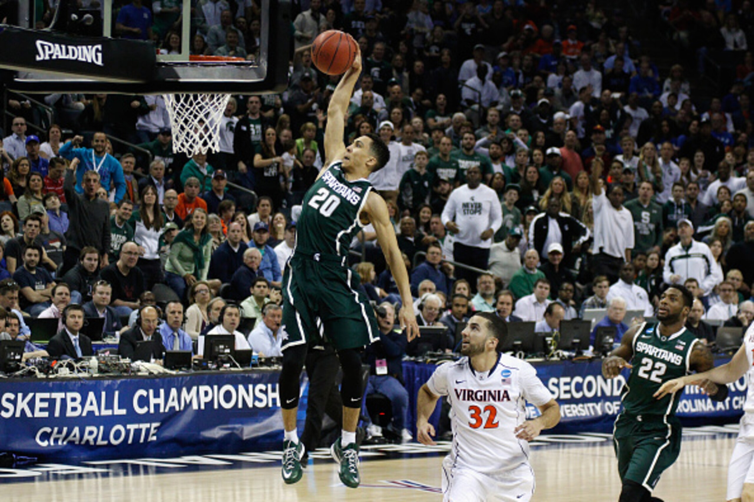 CHARLOTTE, NC - MARCH 22:  Travis Trice #20 of the Michigan State Spartans drives to the basket against the Virginia Cavaliers during the third round of the 2015 NCAA Men's Basketball Tournament at Time Warner Cable Arena on March 22, 2015 in Charlotte, N