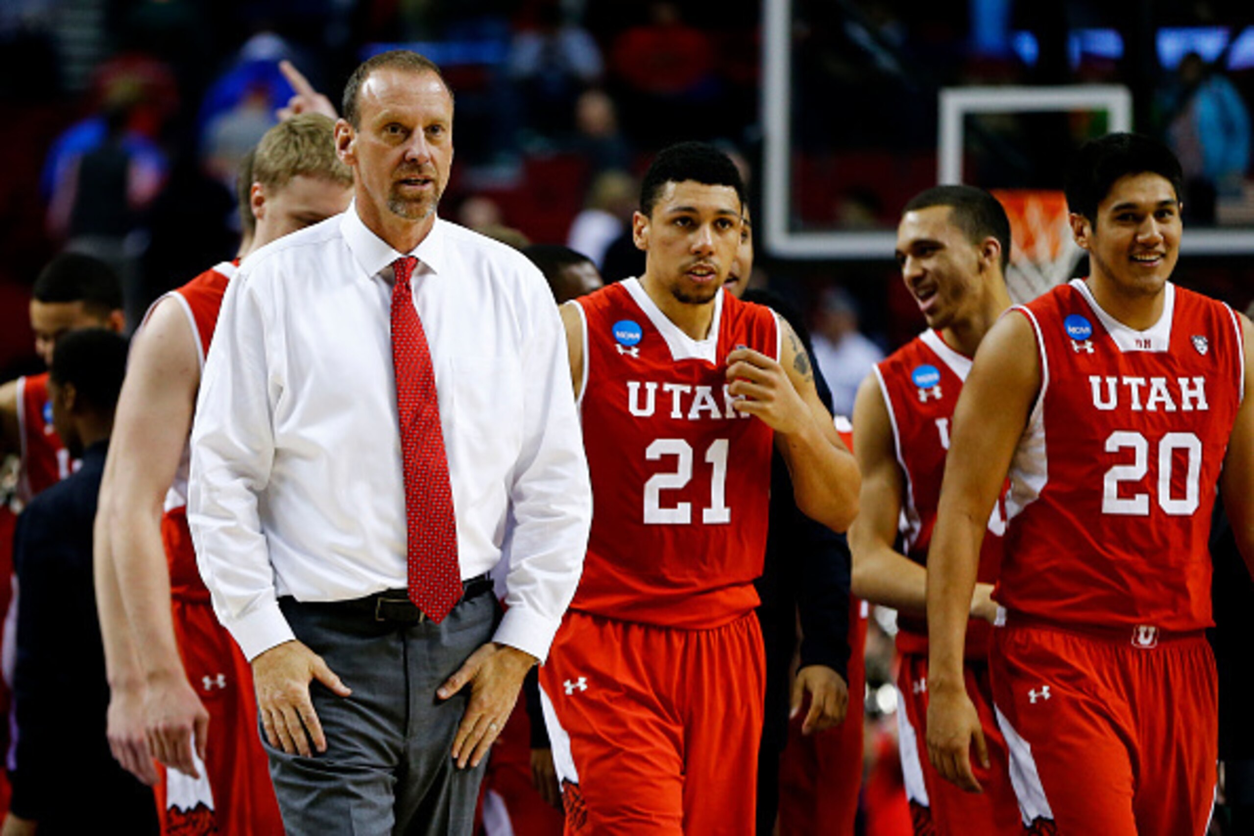 PORTLAND, OR - MARCH 21:  Head coach Larry Krystkowiak of the Utah Utes and his team celebrate their 75 to 64 win over the Georgetown Hoyas during the third round of the 2015 NCAA Men's Basketball Tournament at Moda Center on March 21, 2015 in Portland, O