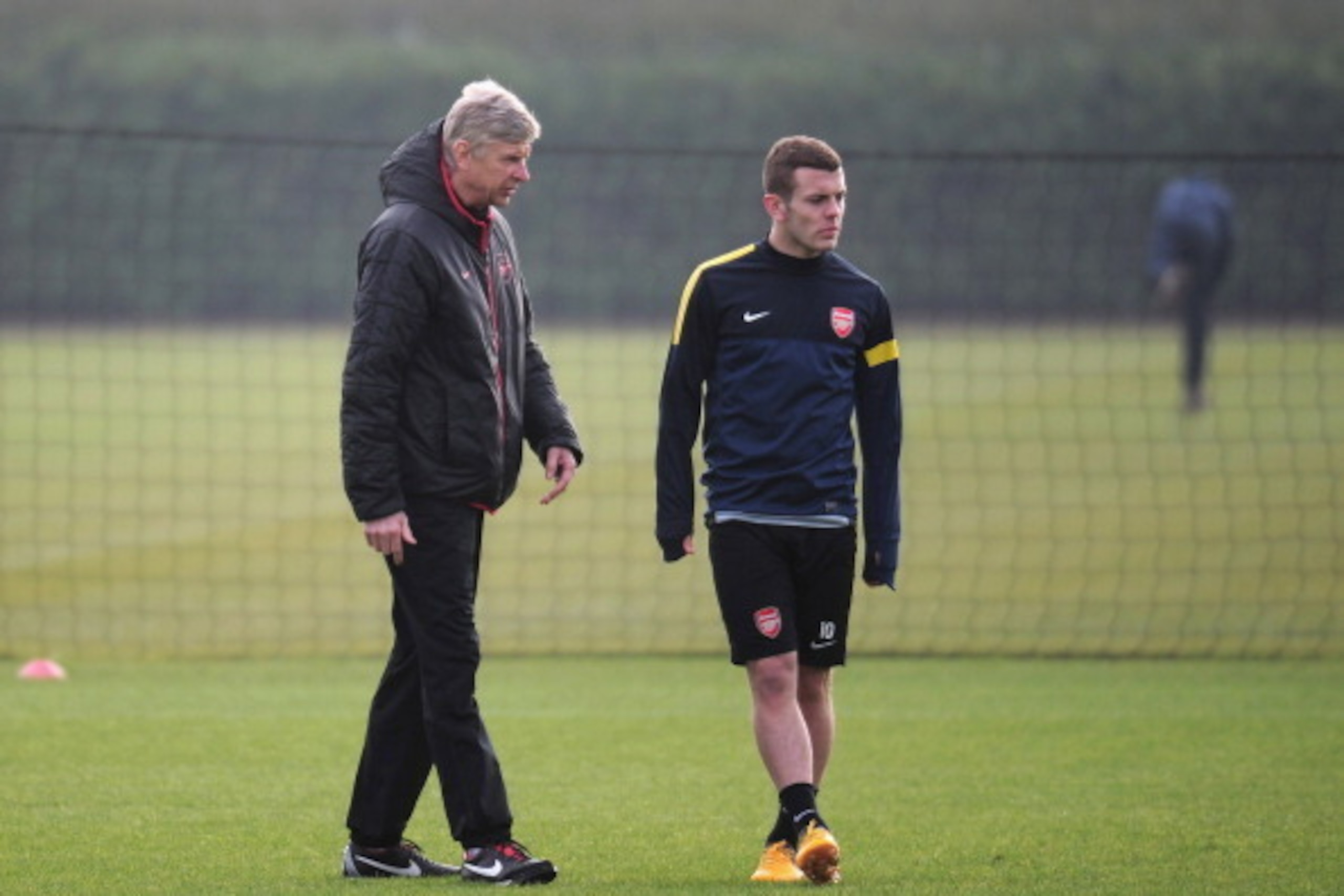 ST ALBANS, ENGLAND - FEBRUARY 18:  Arsenal manager Arsene Wenger talks to Jack Wilshere during a training session ahead of their UEFA Champions League round of 16 first leg match against FC Bayern Muenchen at London Colney on February 18, 2013 in St Alban