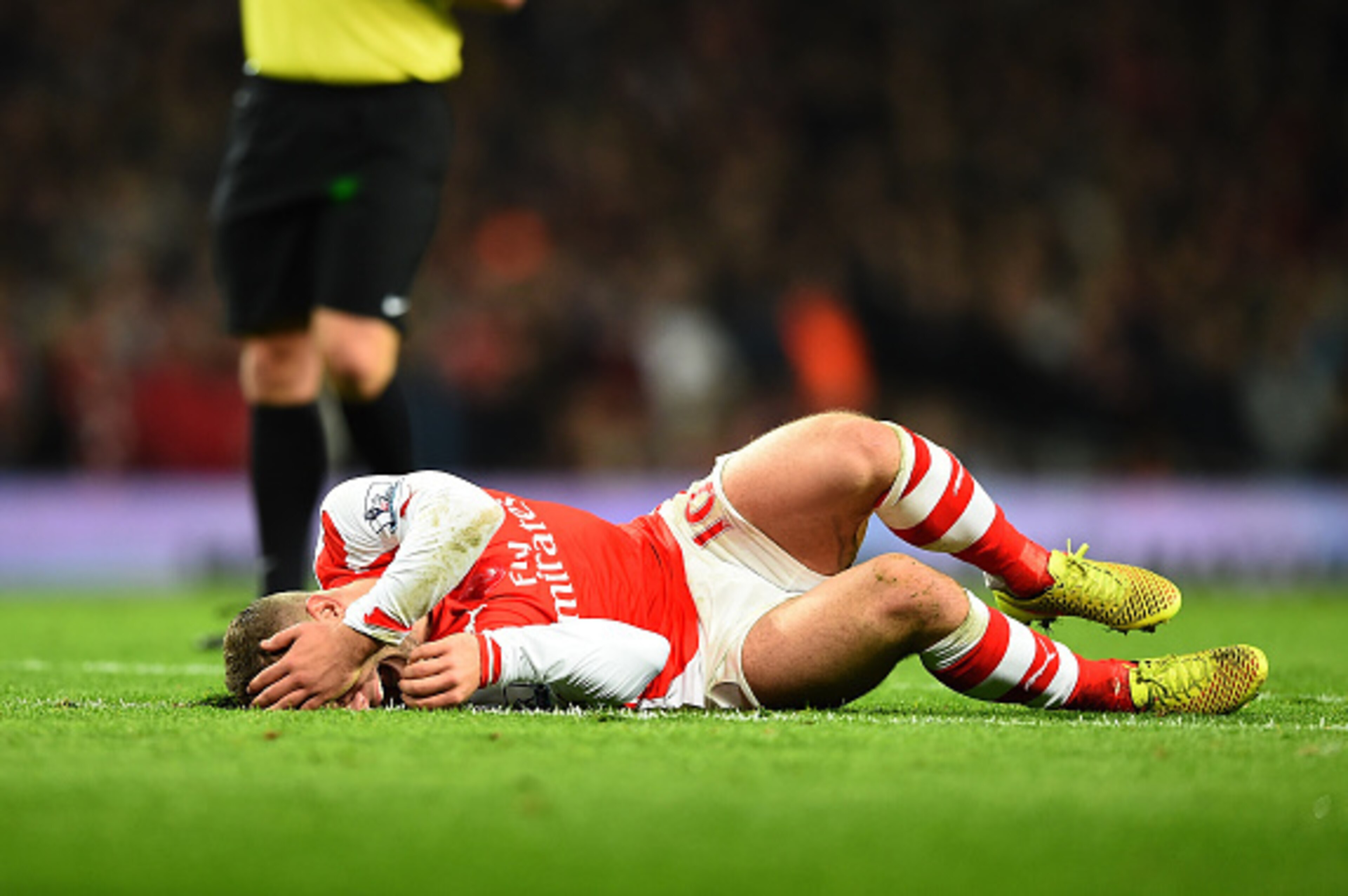 LONDON, ENGLAND - NOVEMBER 22:  Jack Wilshere of Arsenal lies injured after a tackle during the Barclays Premier League match between Arsenal and Manchester United at Emirates Stadium on November 22, 2014 in London, England. (Photo by Shaun Botterill/Gett