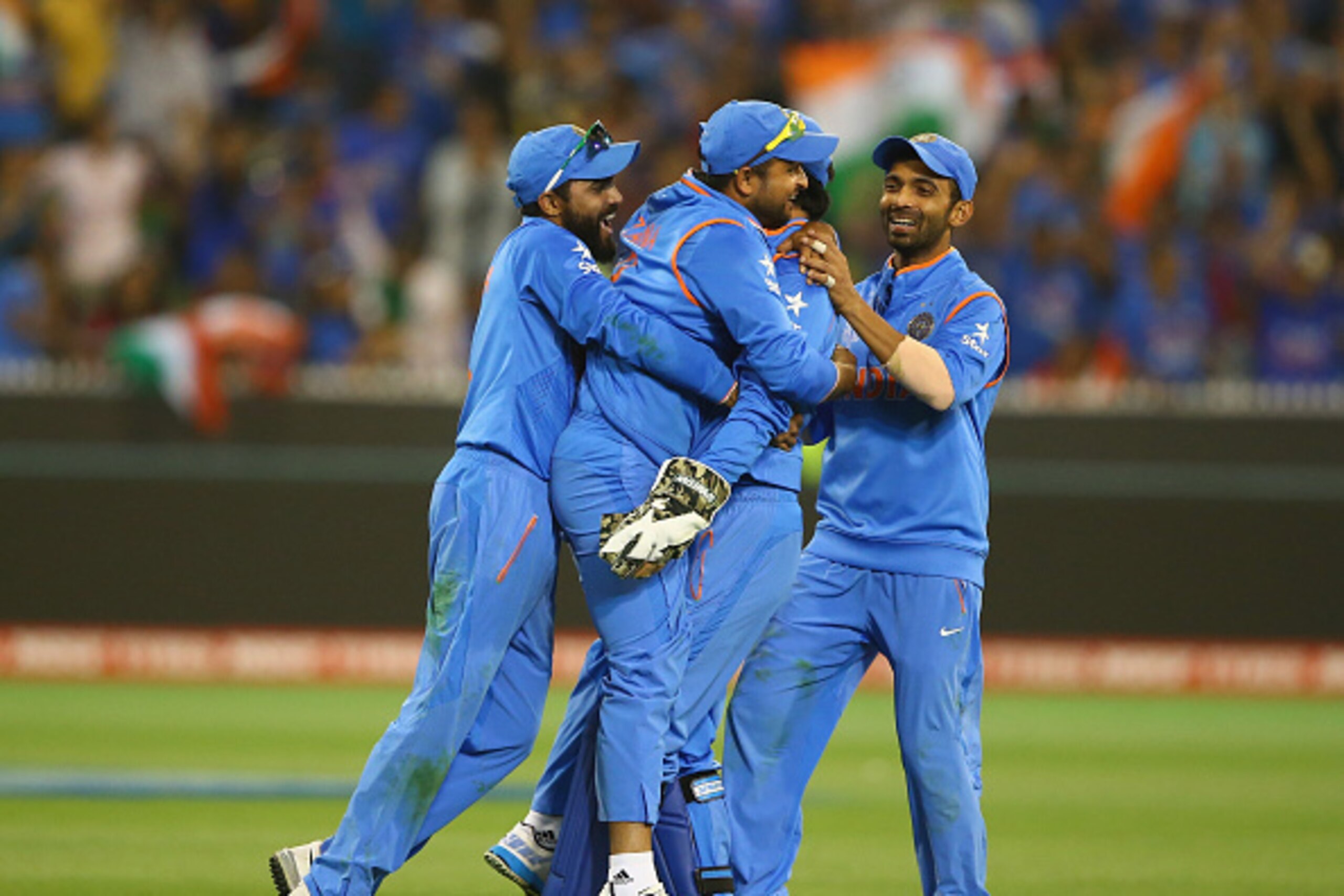 MELBOURNE, AUSTRALIA - MARCH 19:  MS Dhoni and Suresh Raina of India celebrate taking the wicket of Soumya Sarkar of Bangladesh during the 2015 ICC Cricket World Cup match between India and Bangldesh at Melbourne Cricket Ground on March 19, 2015 in Melbou