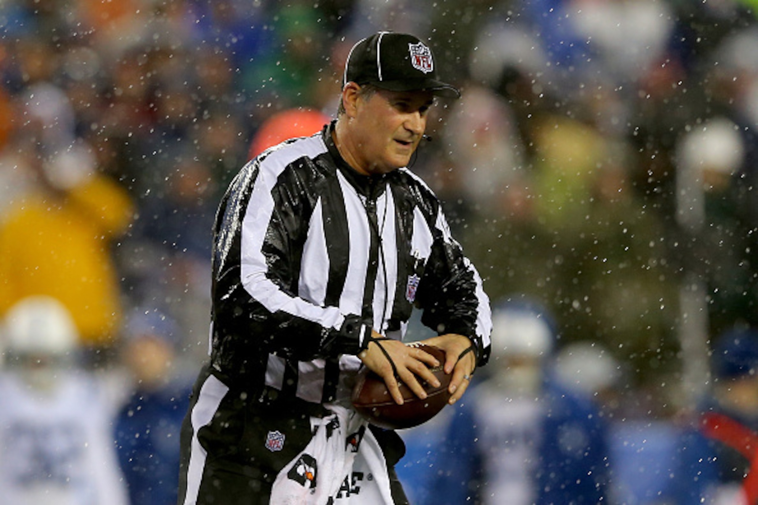 FOXBORO, MA - JANUARY 18:  Umpire Carl Paganelli #124 holds a ball on the field after a play during the 2015 AFC Championship Game between the New England Patriots and the Indianapolis Colts at Gillette Stadium on January 18, 2015 in Foxboro, Massachusett