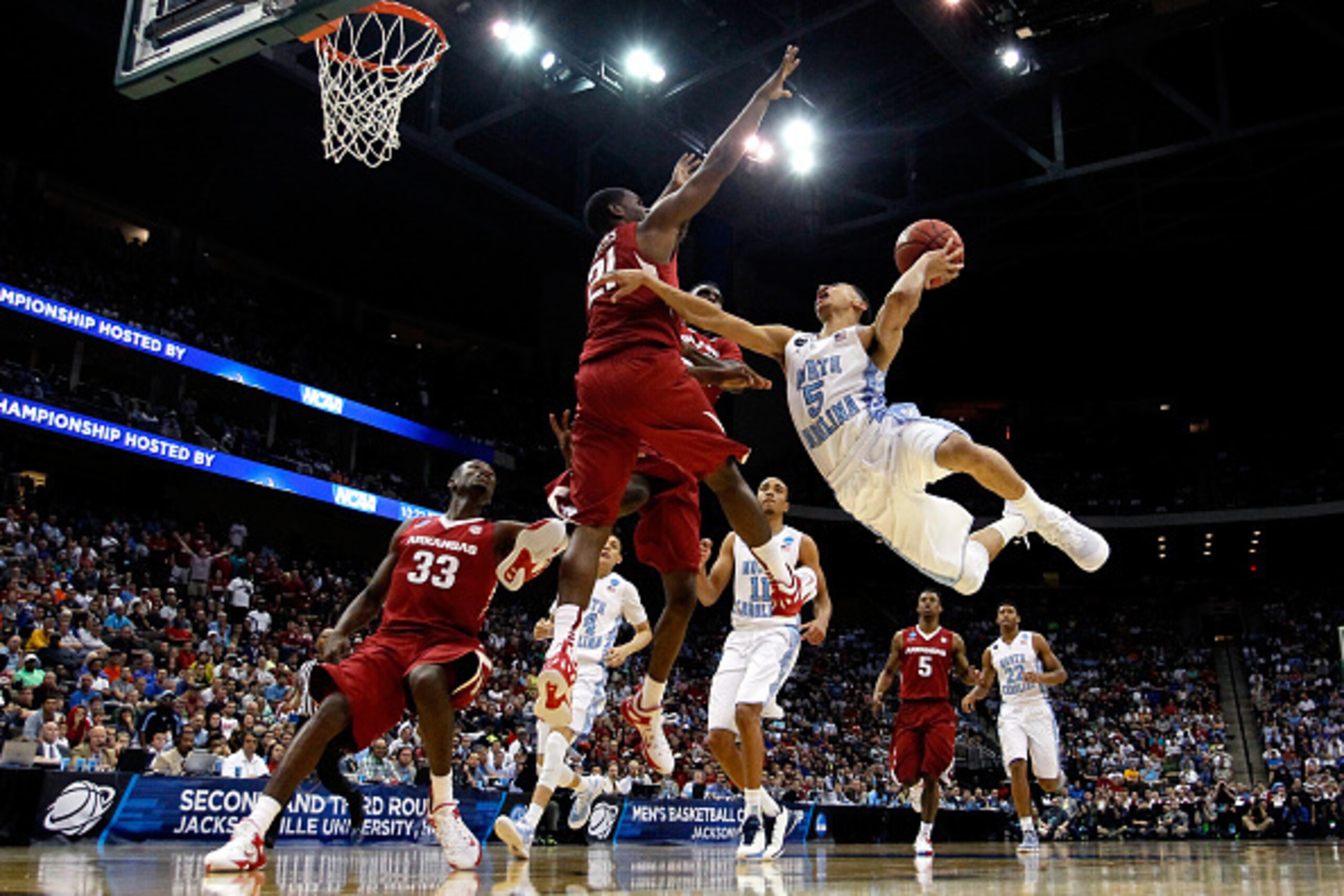 JACKSONVILLE, FL - MARCH 21:  Marcus Paige #5 of the North Carolina Tar Heels puts up a shot as he is defended by Manuale Watkins #21 of the Arkansas Razorbacks in the second half during the third round of the 2015 NCAA Men's Basketball Tournament at Jack