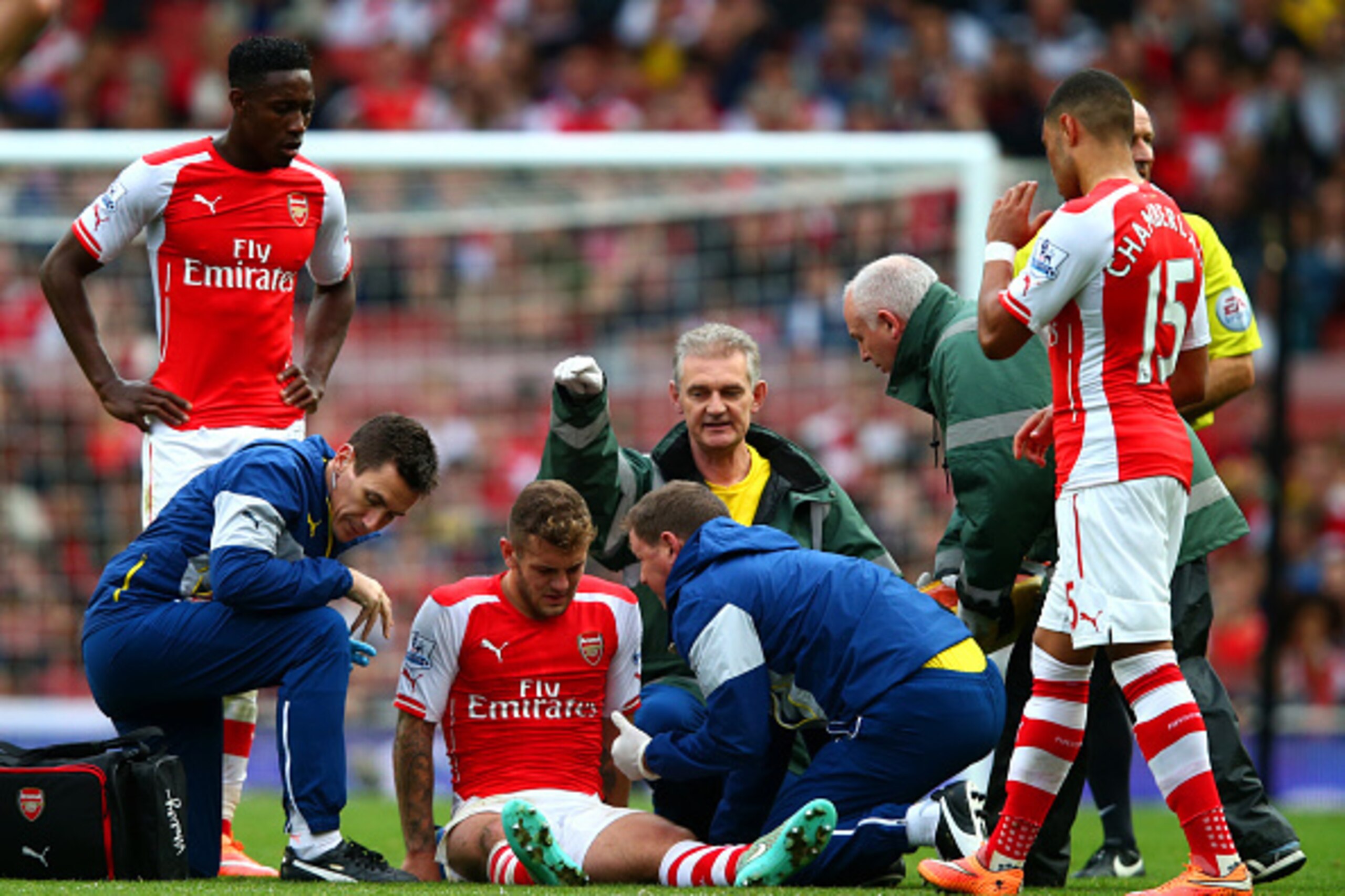 LONDON, ENGLAND - OCTOBER 18:  Jack Wilshere of Arsenal receives treatment after picking up an injury during the Barclays Premier League match between Arsenal and Hull City at Emirates Stadium on October 18, 2014 in London, England.  (Photo by Clive Rose/