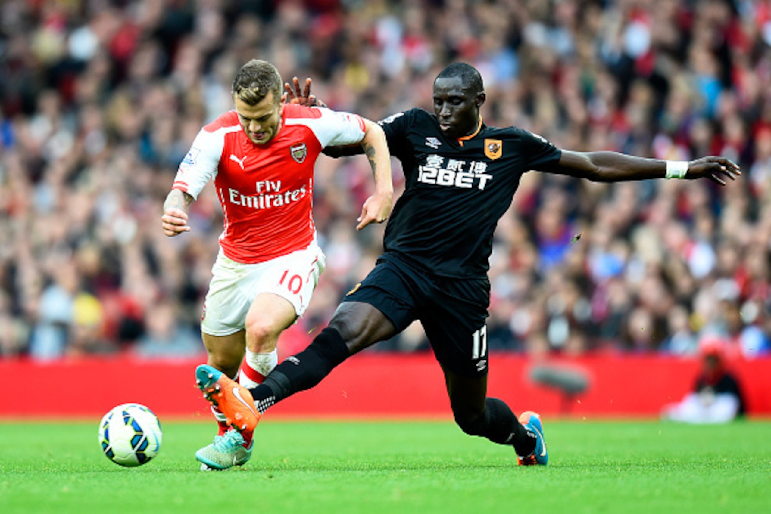 LONDON, ENGLAND - OCTOBER 18:  Mohamed Diame battles for the ball with Jack Wilshere of Arsenal during the Barclays Premier League match between Arsenal and Hull City at Emirates Stadium on October 18, 2014 in London, England.  (Photo by Mike Hewitt/Getty