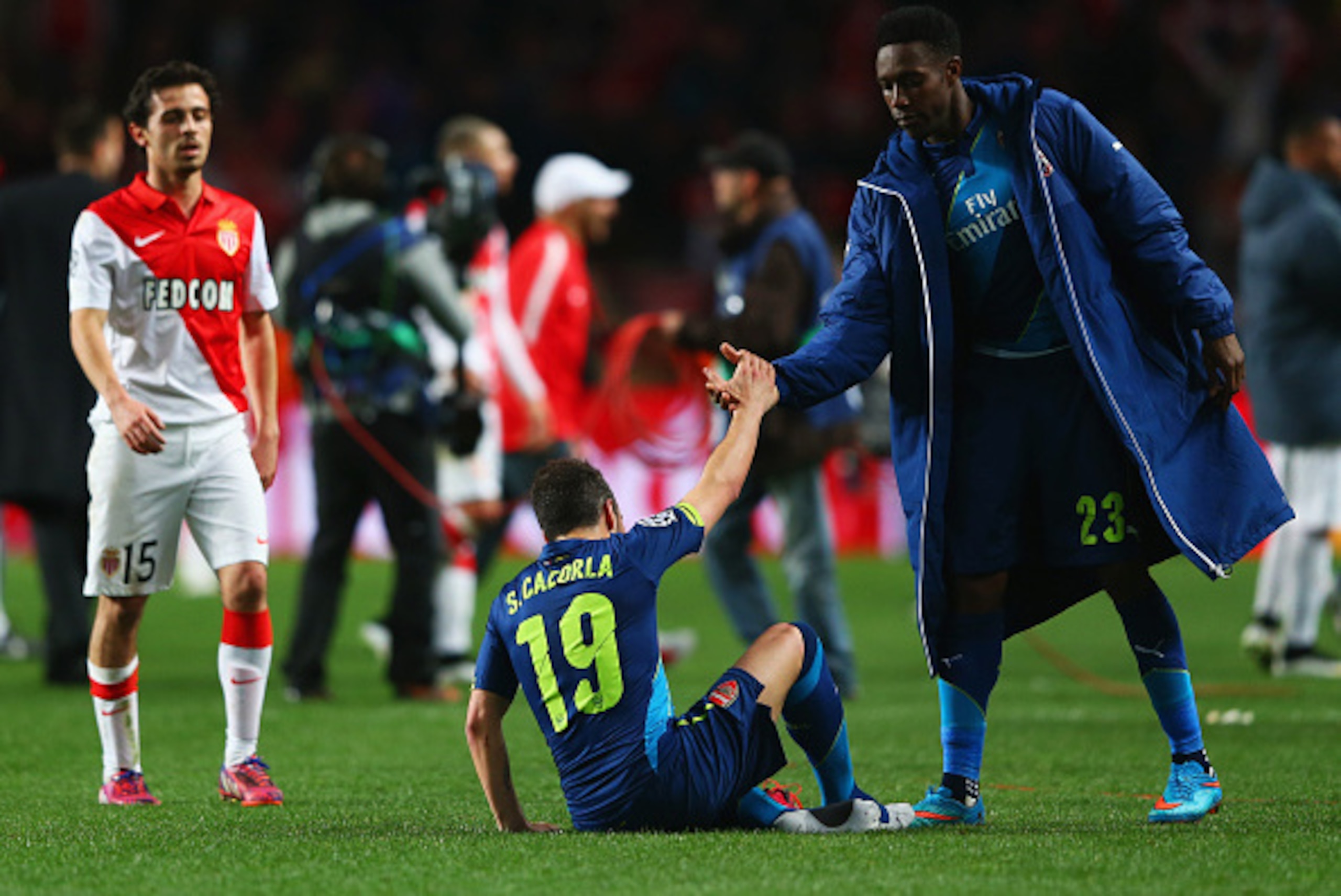 MONACO - MARCH 17: Danny Welbeck of Arsenal consoles team mate Santi Cazorla (19) as they eliminated after the UEFA Champions League round of 16 second leg match between AS Monaco and Arsenal at Stade Louis II on March 17, 2015 in Monaco, Monaco. Arsenal MONACO - MARCH 17: Danny Welbeck of Arsenal consoles team mate Santi Cazorla (19) as they eliminated after the UEFA Champions League round of 16 second leg match between AS Monaco and Arsenal at Stade Louis II on March 17, 2015 in Monaco, Monaco. Arsenal