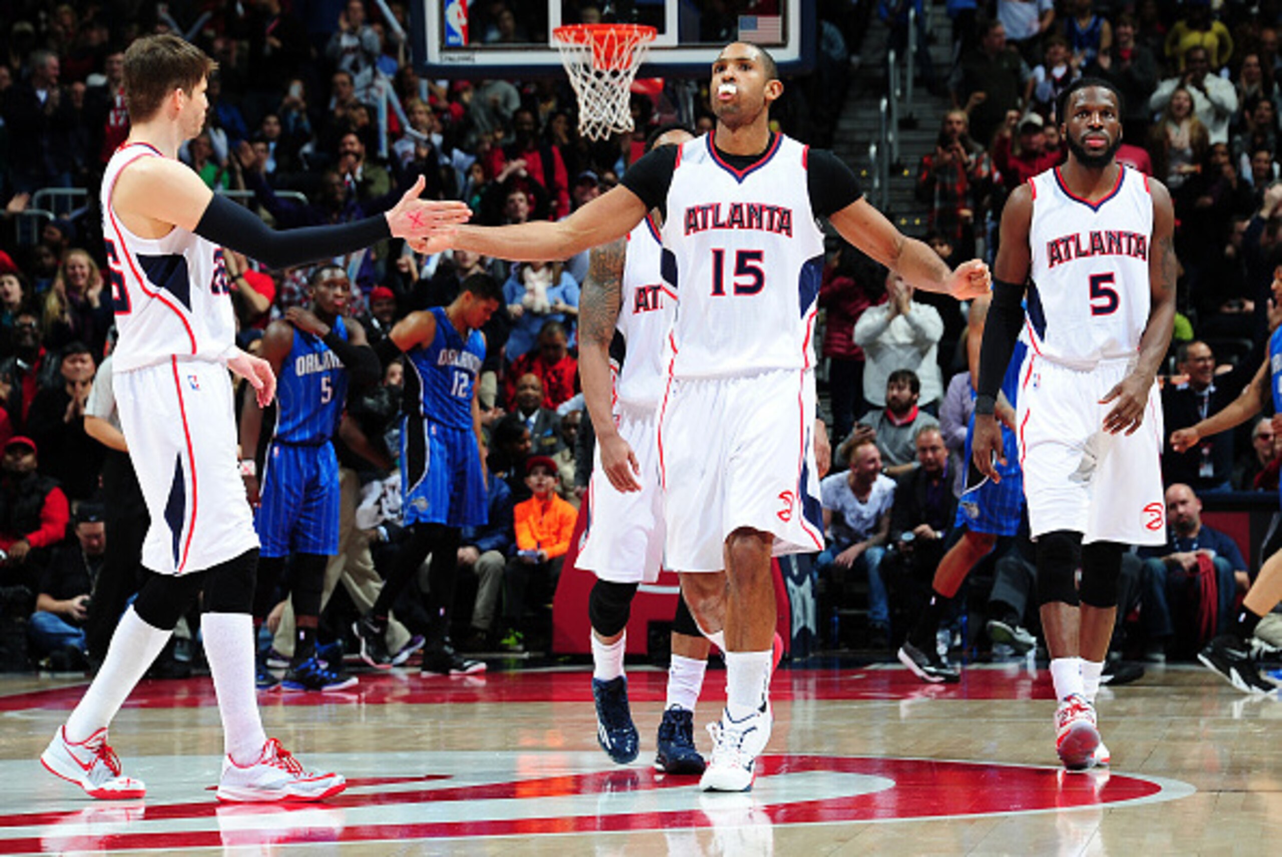 ATLANTA, GA - FEBRUARY 27: Al Horford #15 of the Atlanta Hawks is congratulated by Kyle Korver #26 after scoring against the Orlando Magic on February 27, 2015 at Philips Arena in Atlanta, Georgia.  NOTE TO USER: User expressly acknowledges and agrees tha