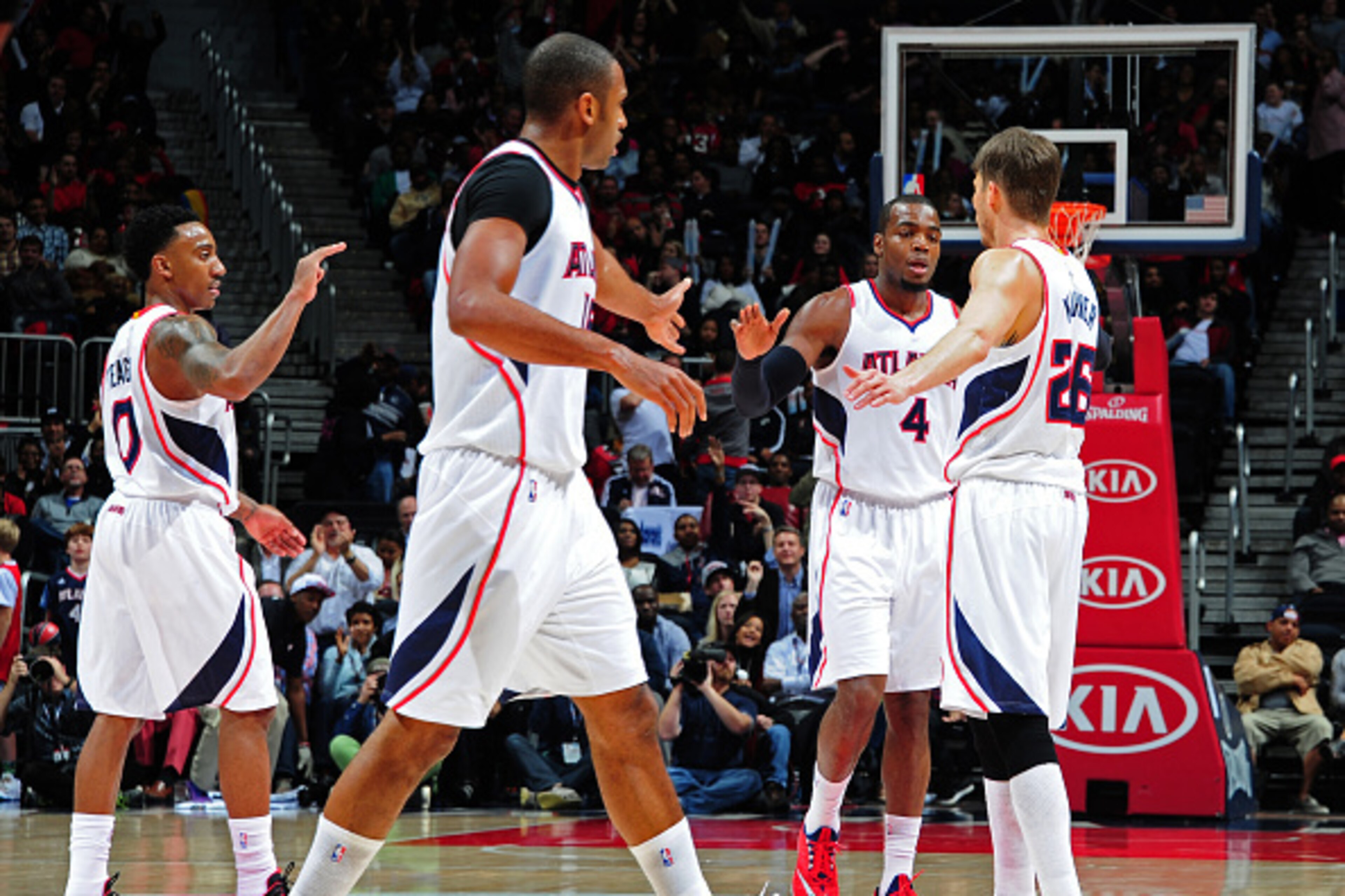 ATLANTA, GA - JANUARY 21:Jeff Teague #0, Al Horford #15, Paul Millsap #4, and Kyle Korver #26 of the Atlanta Hawks celebrate after a score against the Indiana Pacers on January 21, 2015 at Philips Arena in Atlanta, Georgia.  NOTE TO USER: User expressly a