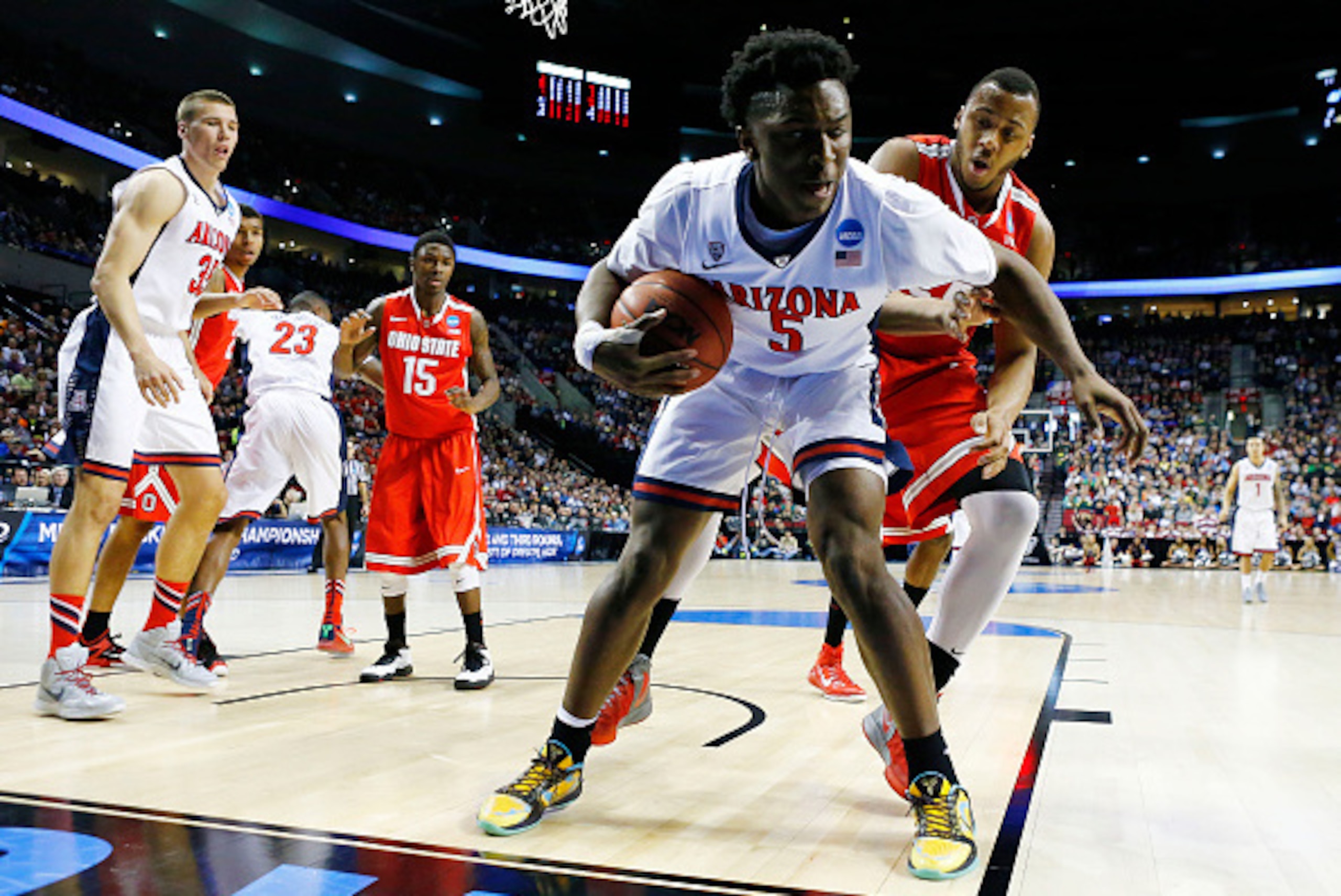 PORTLAND, OR - MARCH 21:  Stanley Johnson #5 of the Arizona Wildcats controls the ball against Trey McDonald #55 of the Ohio State Buckeyes in the first half during the third round of the 2015 NCAA Men's Basketball Tournament at Moda Center on March 21, 2