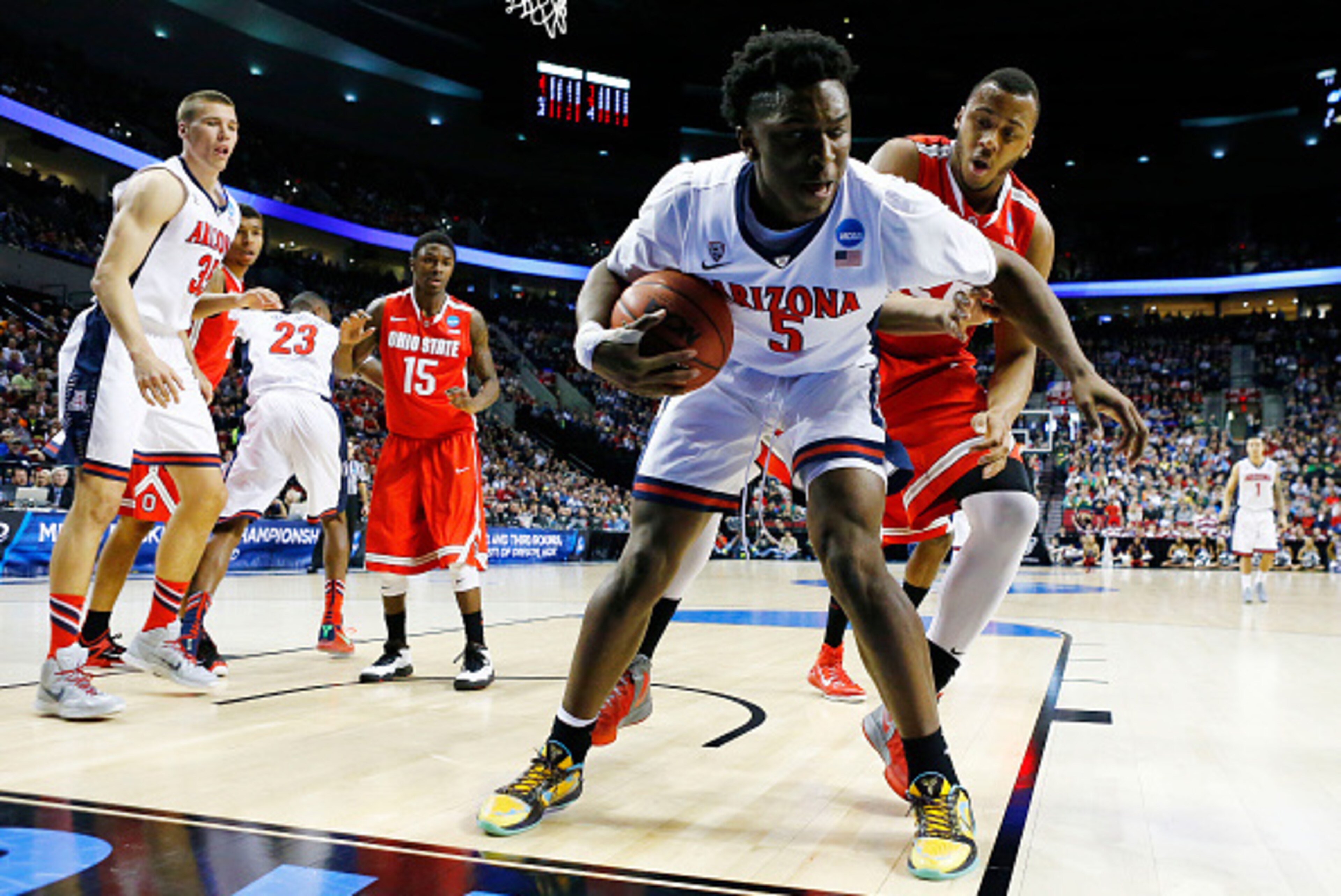 PORTLAND, OR - MARCH 21:  Stanley Johnson #5 of the Arizona Wildcats controls the ball against Trey McDonald #55 of the Ohio State Buckeyes in the first half during the third round of the 2015 NCAA Men's Basketball Tournament at Moda Center on March 21, 2