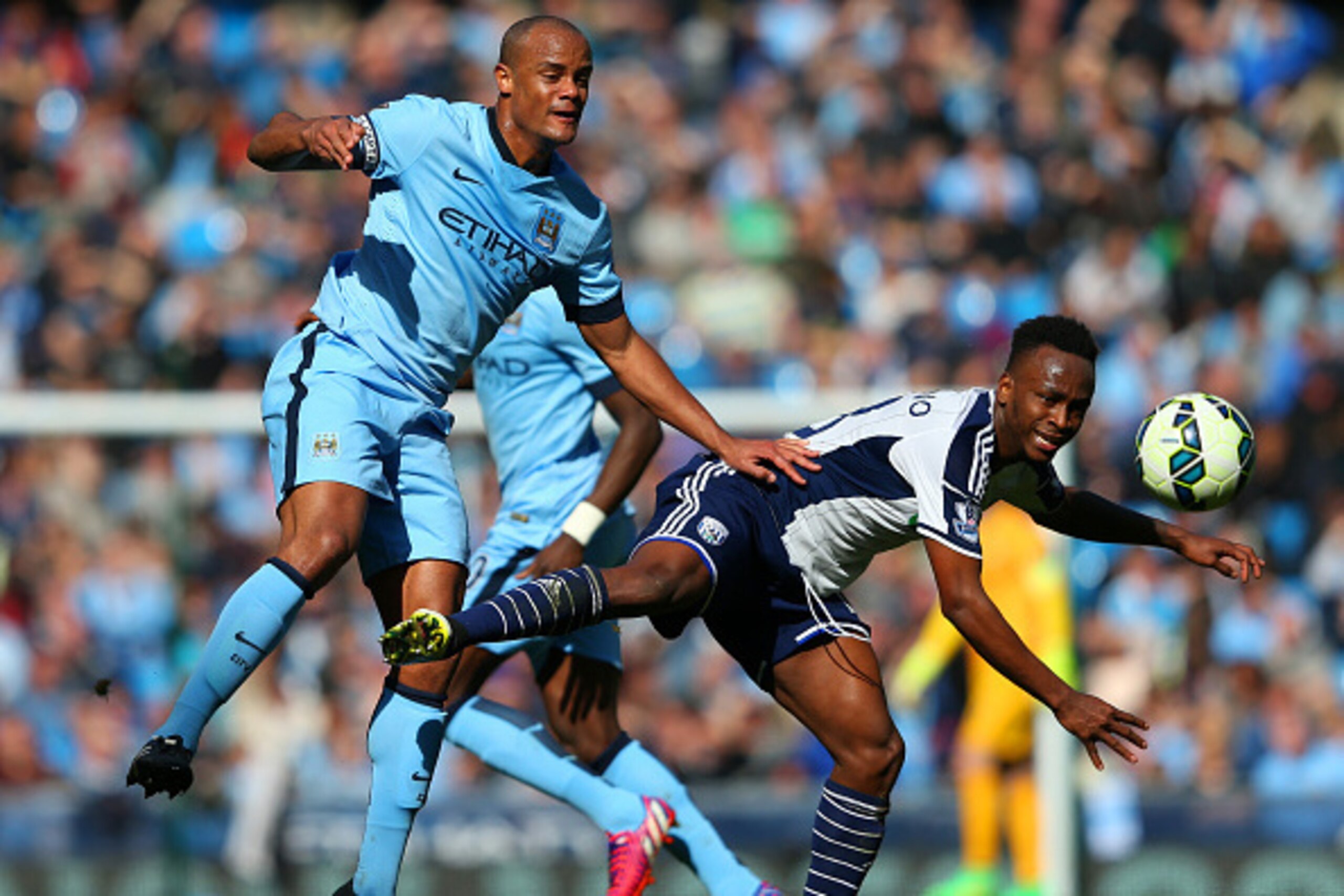 MANCHESTER, ENGLAND - MARCH 21:  Vincent Kompany of Manchester City and Saido Berahino of West Brom batlte for the ball during the Barclays Premier League match between Manchester City and West Bromwich Albion at Etihad Stadium on March 21, 2015 in Manche
