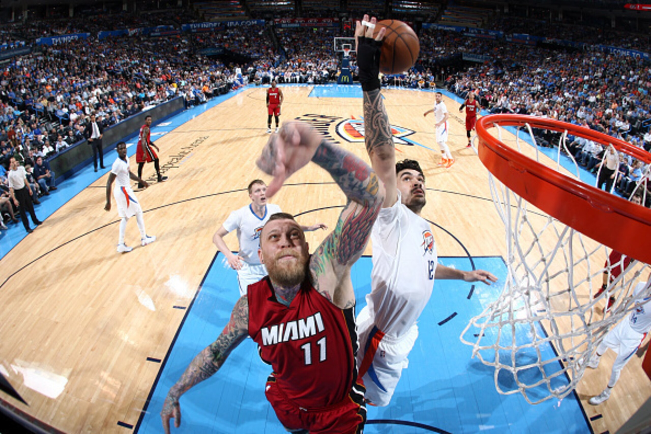 OKLAHOMA CITY, OK- March 22: Steven Adams #12 of the Oklahoma City Thunder grabs a rebound against Chris Andersen #11 of the Miami Heat on March 22, 2015 at Chesapeake Energy Arena in Oklahoma City, Oklahoma. NOTE TO USER: User expressly acknowledges and 