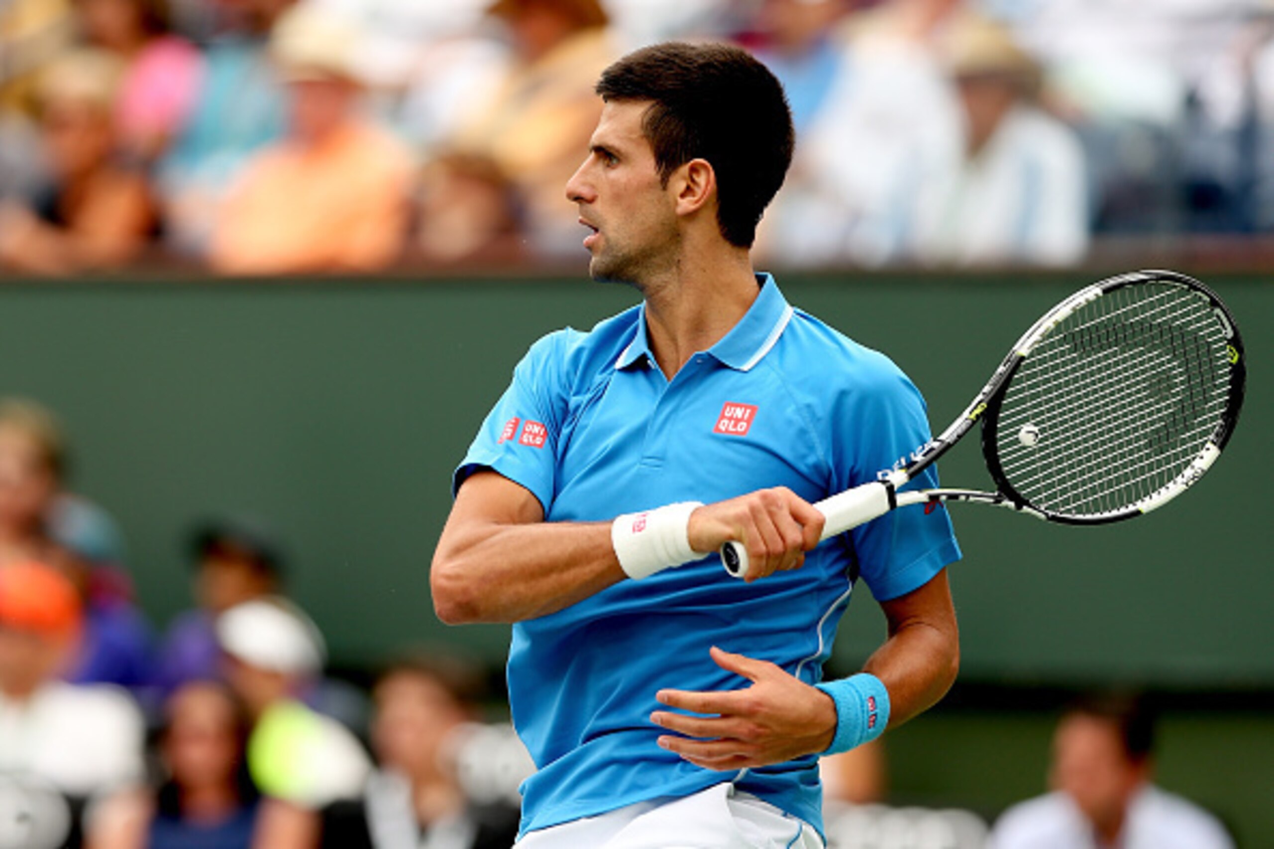 INDIAN WELLS, CA - MARCH 22:  Novak Djokovic of Serbia returns a shot to Roger Federer of Switzerland during the final on day fourteen of the BNP Paribas Open at the Indian Wells Tennis Garden on March 22, 2015 in Indian Wells, California.  (Photo by Matt