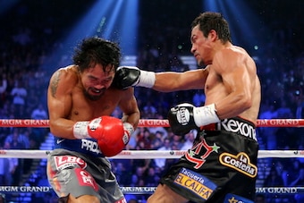 LAS VEGAS, NV - DECEMBER 08:  (R-L) Juan Manuel Marquez lands a right to the face of Manny Pacquiao during their welterweight bout at the MGM Grand Garden Arena on December 8, 2012 in Las Vegas, Nevada.  (Photo by Al Bello/Getty Images)