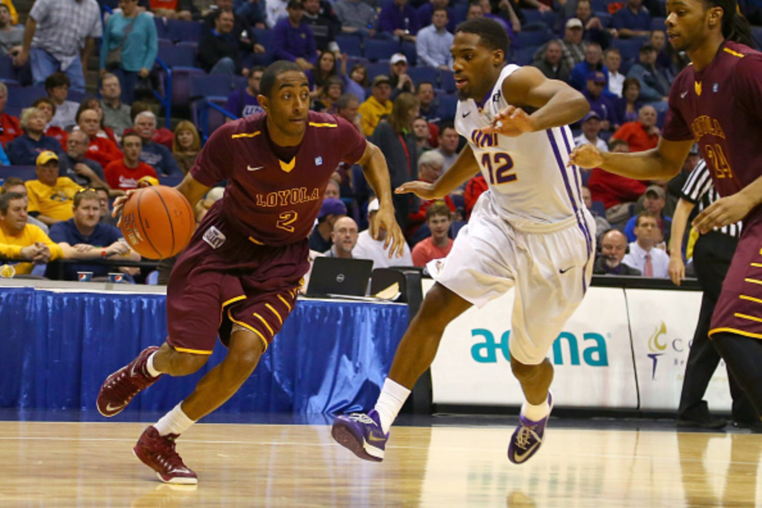 ST. LOUIS, MO - MARCH 7: Earl Peterson #2 of the Loyola (IL) Ramblers drives past Marvin Singleton #12 of the Northern Iowa Panthers during the MVC Basketball Tournament Semifinals at the Scottrade Center on March 7, 2015 in St. Louis, Missouri.  (Photo b
