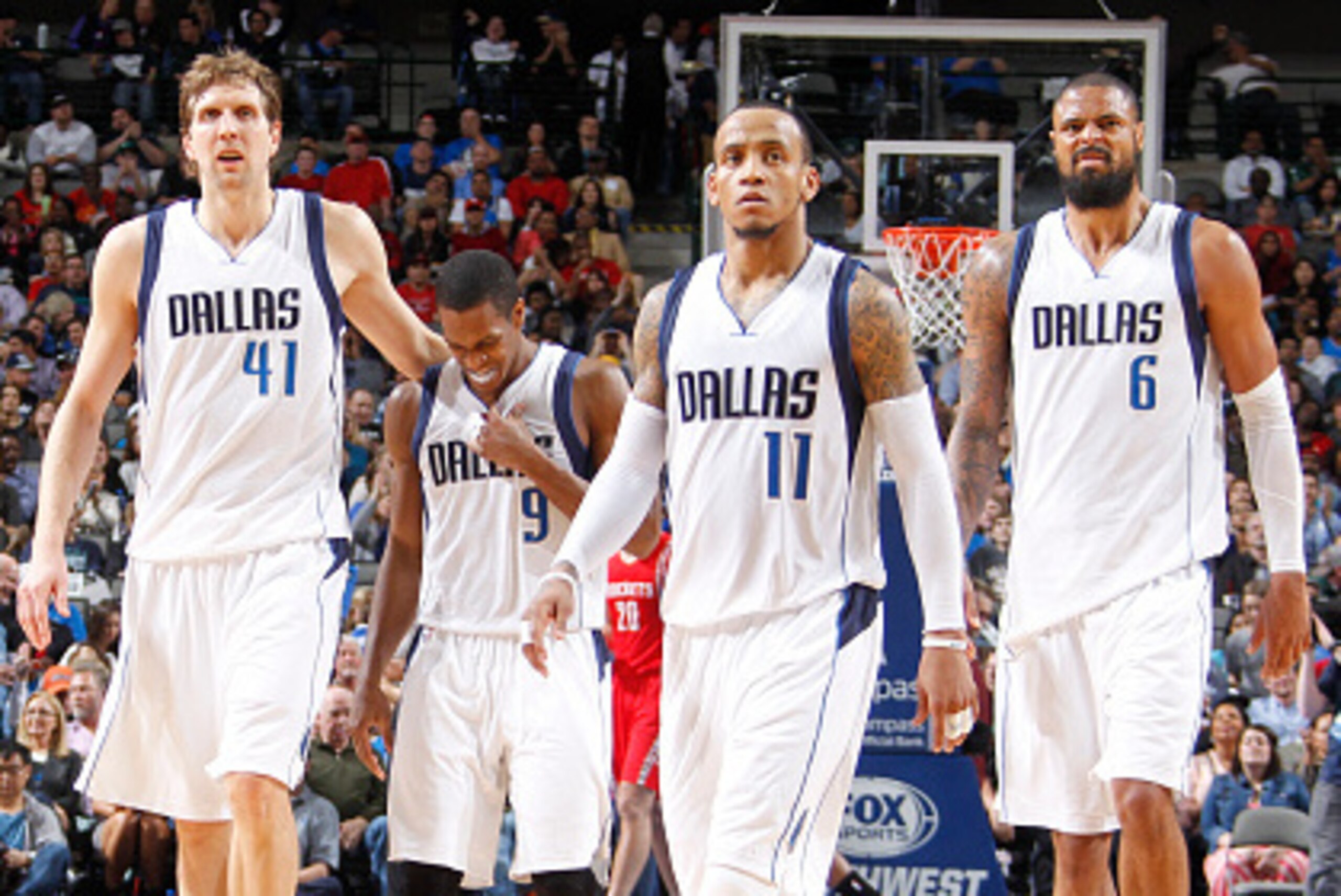 DALLAS, TX - FEBRUARY 20: Dirk Nowitzki #41, Rajon Rondo #9, Monta Ellis #11, and Tyson Chandler #6 of the Dallas Mavericks stand on the court during a game against the Houston Rockets on February 20, 2015 at the American Airlines Center in Dallas, Texas.