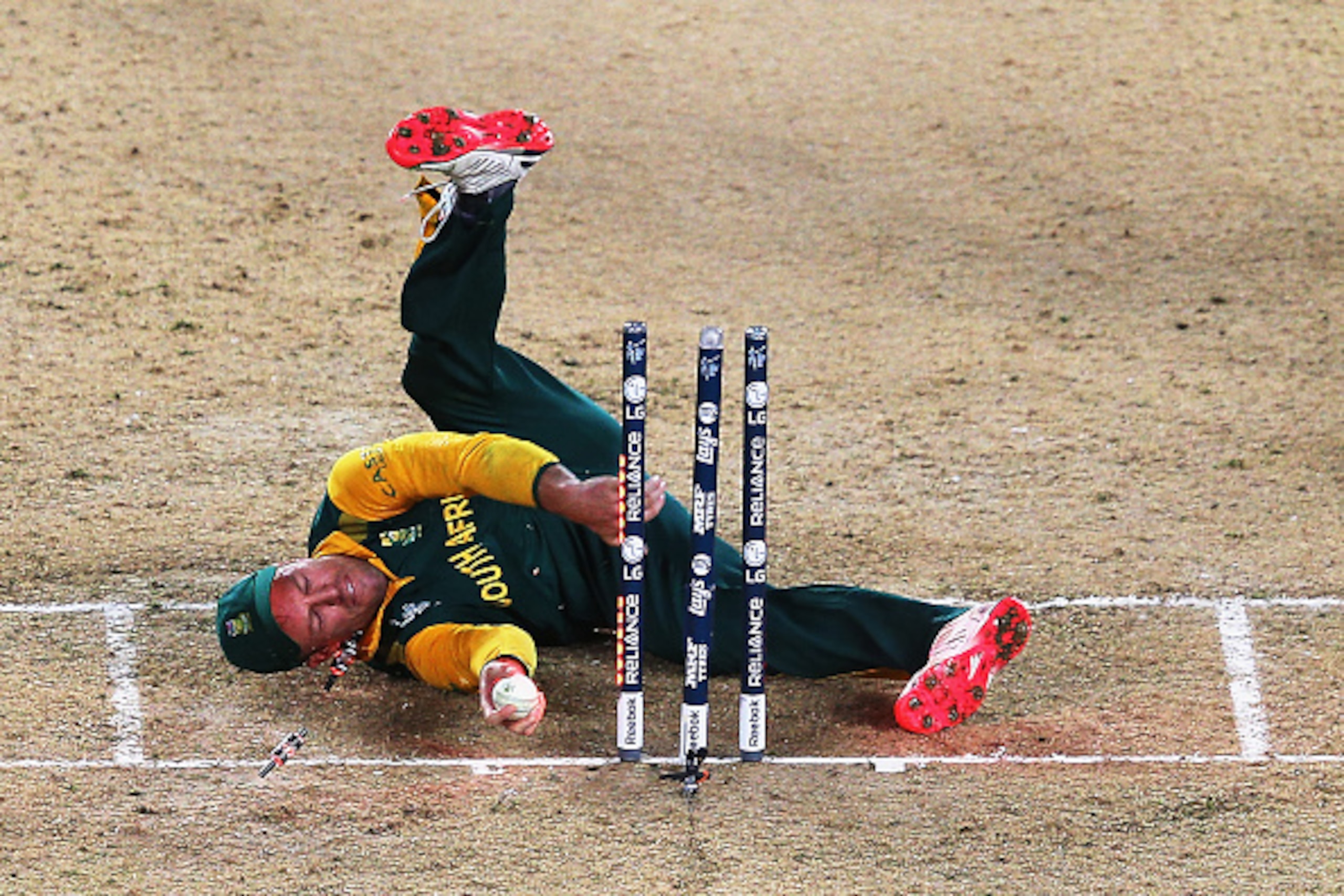 AUCKLAND, NEW ZEALAND - MARCH 24:  AB de Villiers of South Africa falls over the stumps during the 2015 Cricket World Cup Semi Final match between New Zealand and South Africa at Eden Park on March 24, 2015 in Auckland, New Zealand.  (Photo by Hannah Pete