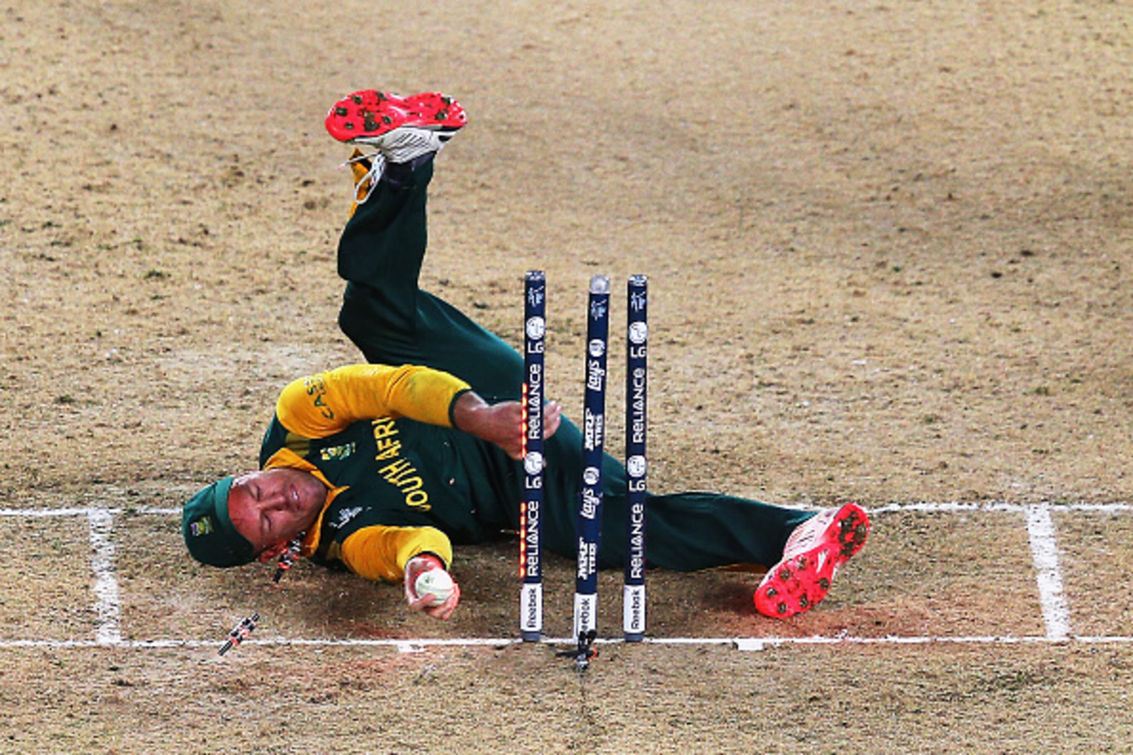 AUCKLAND, NEW ZEALAND - MARCH 24:  AB de Villiers of South Africa falls over the stumps during the 2015 Cricket World Cup Semi Final match between New Zealand and South Africa at Eden Park on March 24, 2015 in Auckland, New Zealand.  (Photo by Hannah Pete