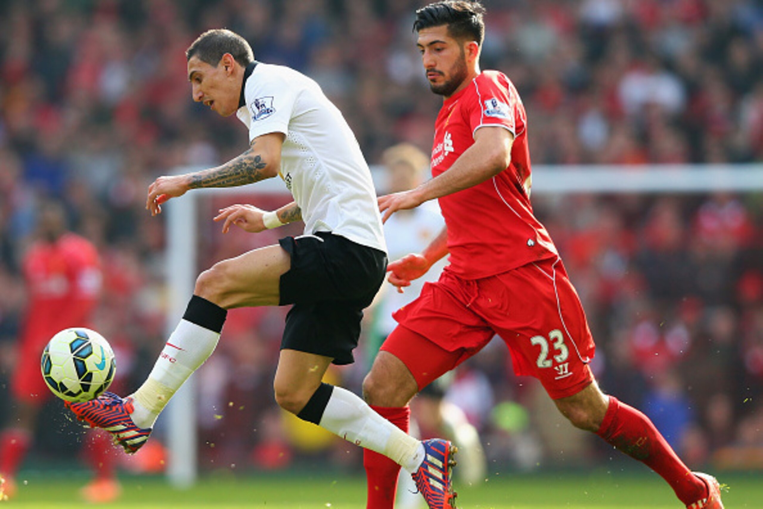 LIVERPOOL, ENGLAND - MARCH 22: Angel Di Maria of Manchester United challenges for the ball with Emre Can of Liverpool during the Barclays Premier League match between Liverpool and Manchester United at Anfield on March 22, 2015 in Liverpool, England. (P LIVERPOOL, ENGLAND - MARCH 22: Angel Di Maria of Manchester United challenges for the ball with Emre Can of Liverpool during the Barclays Premier League match between Liverpool and Manchester United at Anfield on March 22, 2015 in Liverpool, England. (P