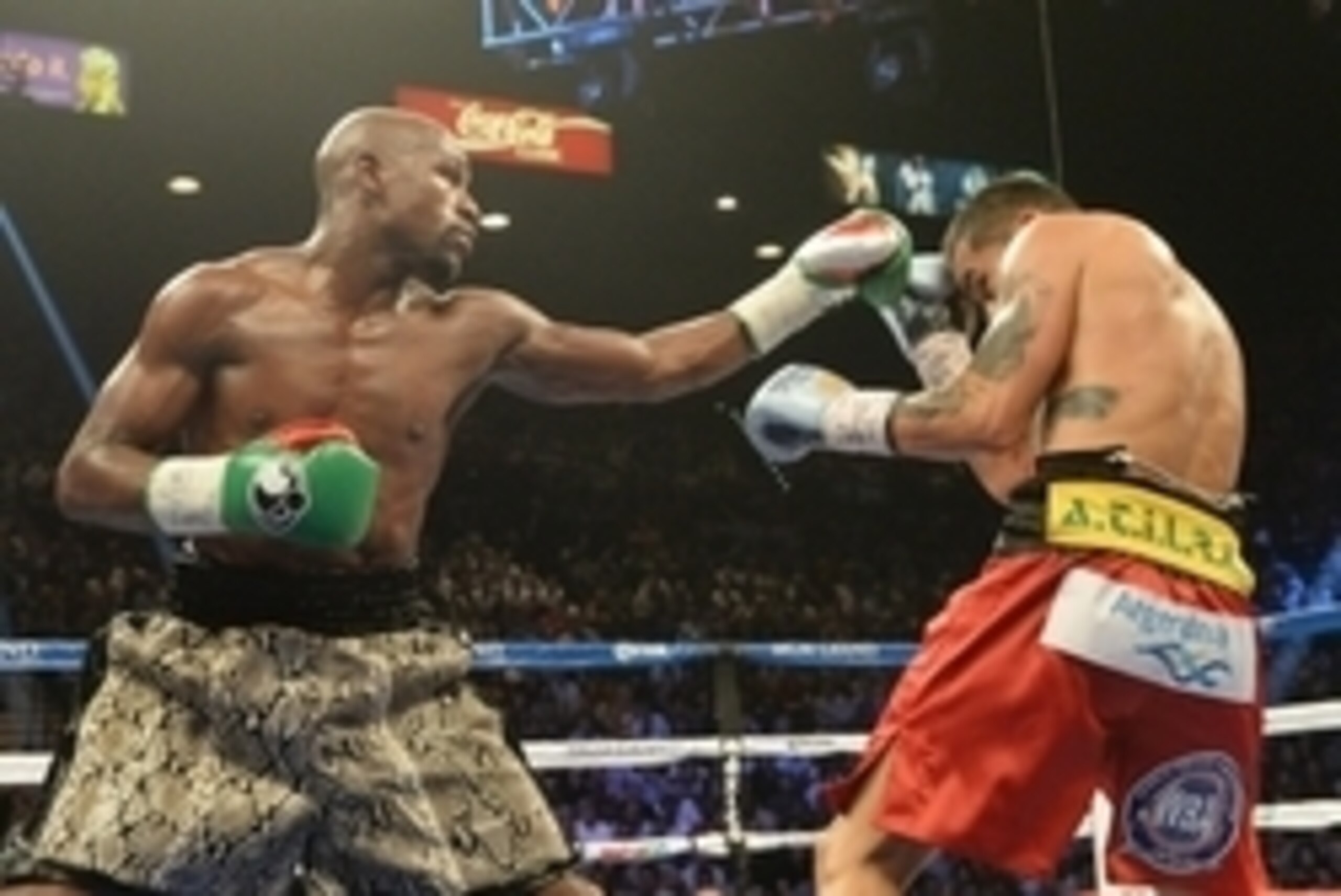 Sep 13, 2014; Las Vegas, NV, USA; Floyd Mayweather (green gloves) and Marcos Maidana (blue gloves) trade punches during their WBC & WBA Welterweight and WBC Superwelter Weight title fight at the MGM Grand Garden Arena. Mandatory Credit: Jayne Kamin-Oncea-