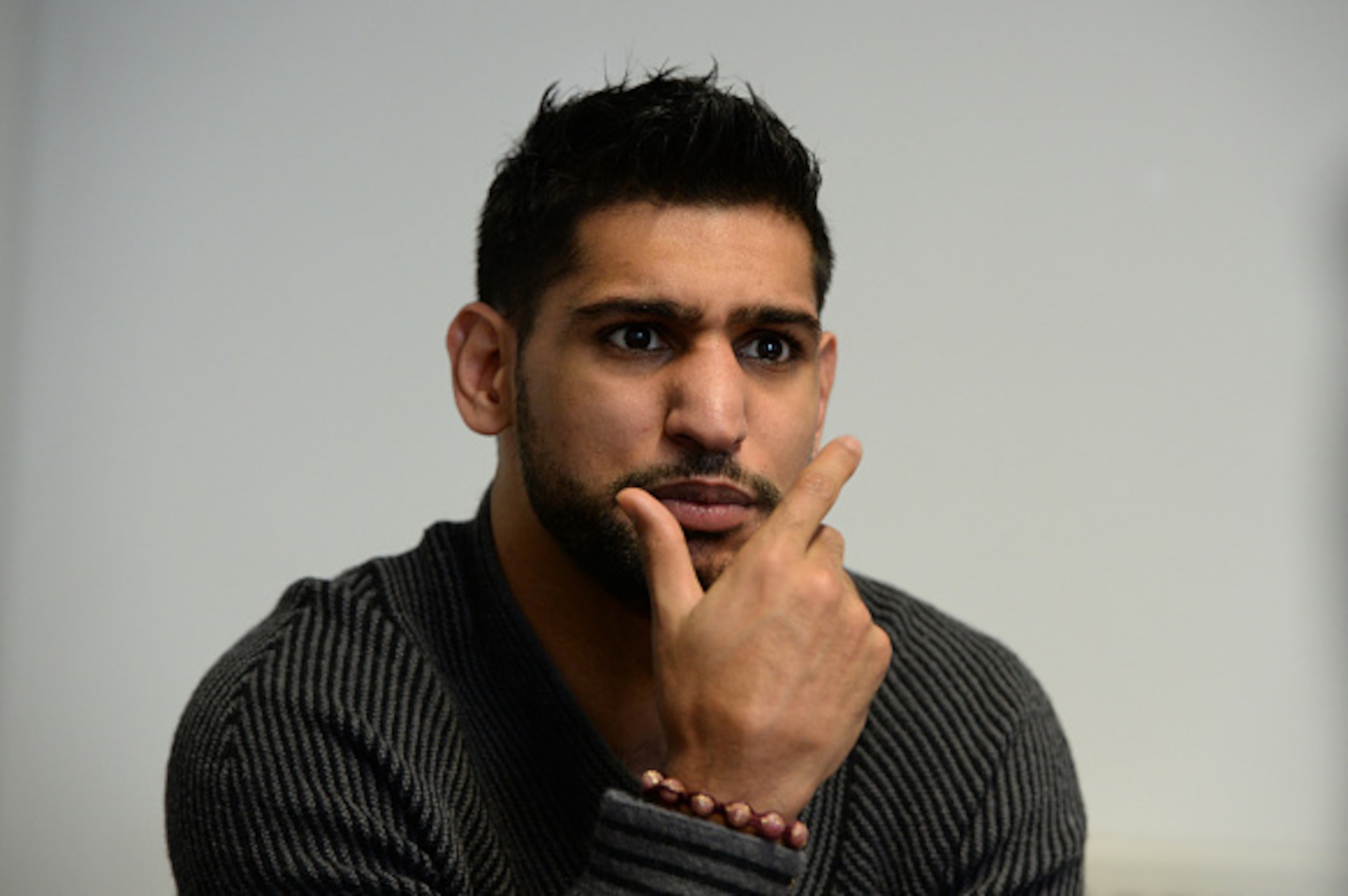 SHEFFIELD, ENGLAND - FEBRUARY 19:  Boxer Amir Khan speaks to media during a visit to Fight Label who make his shorts on February 19, 2015 in Sheffield, England.  (Photo by Nigel Roddis/Getty Images)