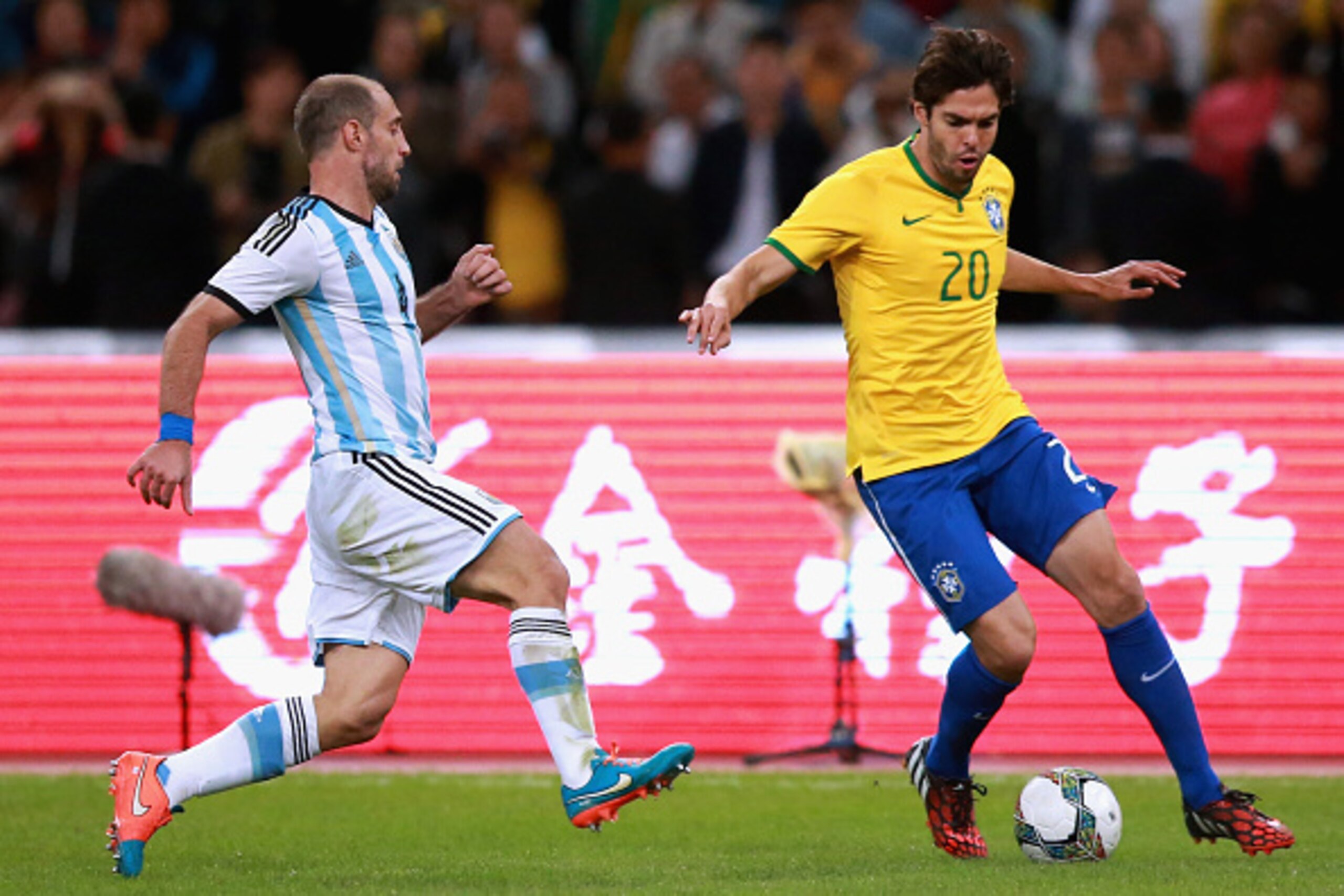 BEIJING, CHINA - OCTOBER 11:  Kaka of Brazil (Right) competes the ball with Zabaleta of Argentina (Left) during Super Clasico de las Americas between Argentina and Brazil at Beijing National Stadium on October 11, 2014 in Beijing, China.  (Photo by Feng L