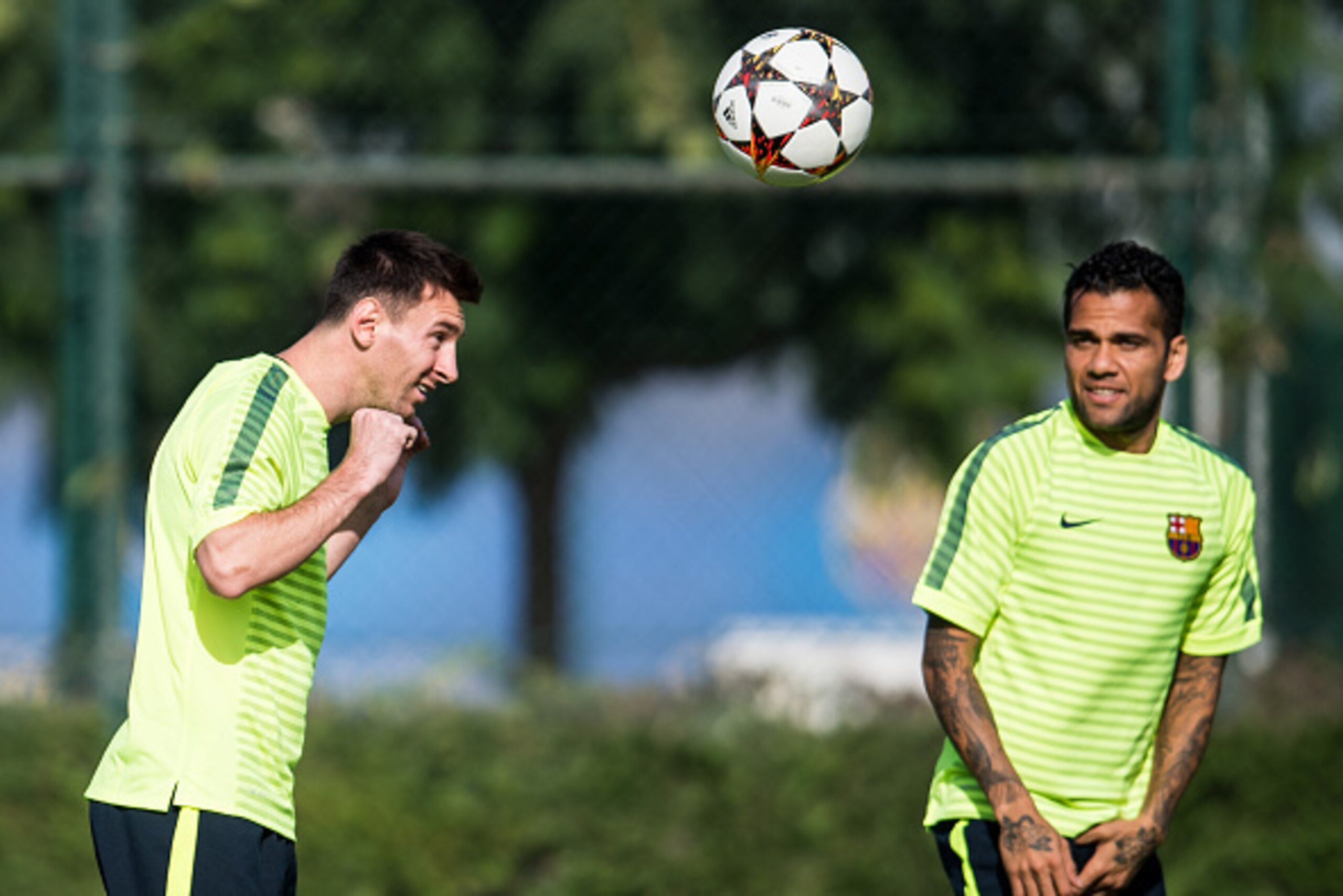 BARCELONA, SPAIN - OCTOBER 20:  Lionel Messi and Dani Alves of FC Barcelona in action during a training session ahead of their UEFA Champions League Group F match against AFC Ajax at Ciutat Esportiva on October 20, 2014 in Barcelona, Spain.  (Photo by Dav