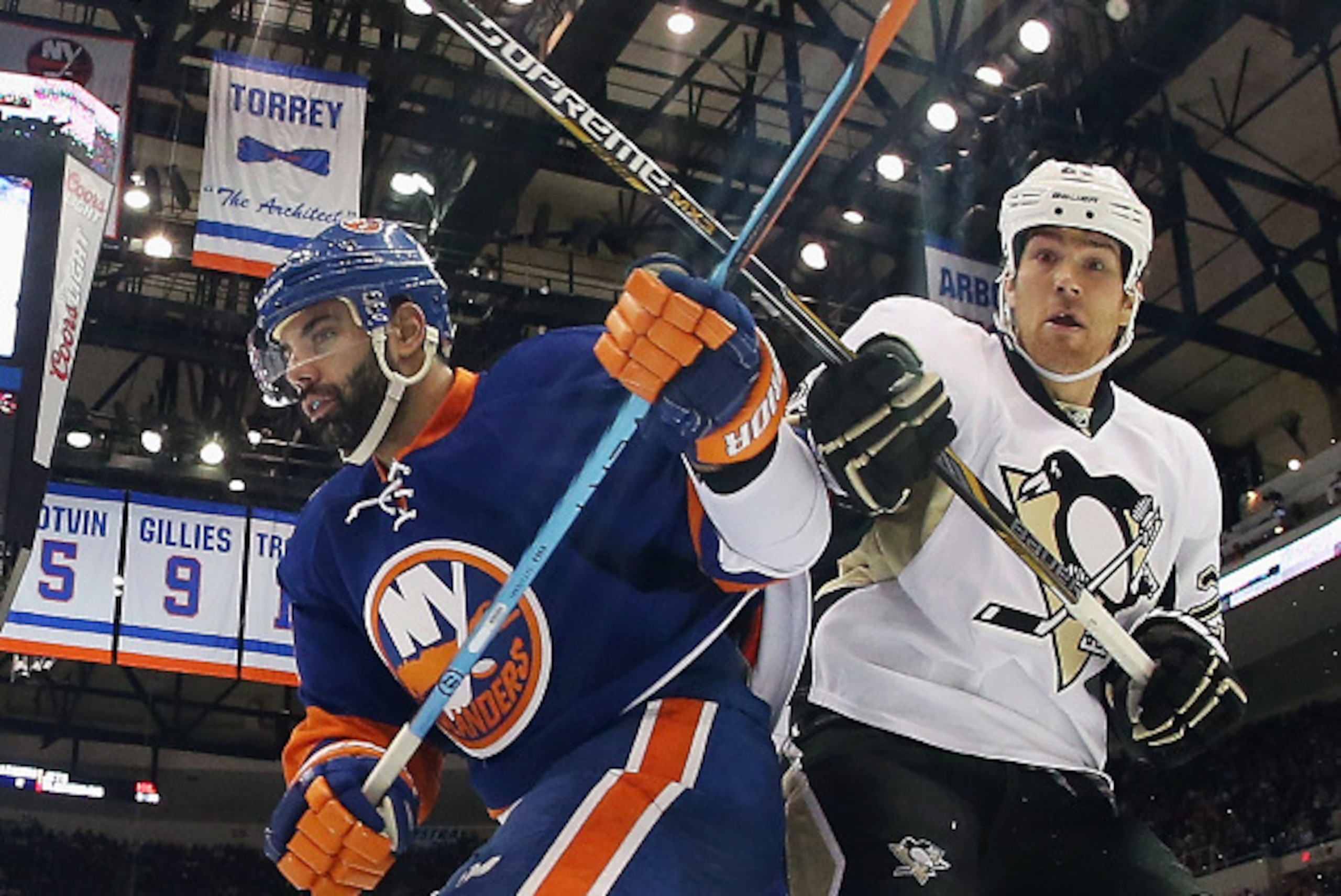 UNIONDALE, NY - JANUARY 16:  Steve Downie #23 of the Pittsburgh Penguins skates against Brian Strait #37 of the New York Islanders at the Nassau Veterans Memorial Coliseum on January 16, 2015 in Uniondale, New York.  (Photo by Bruce Bennett/Getty Images)