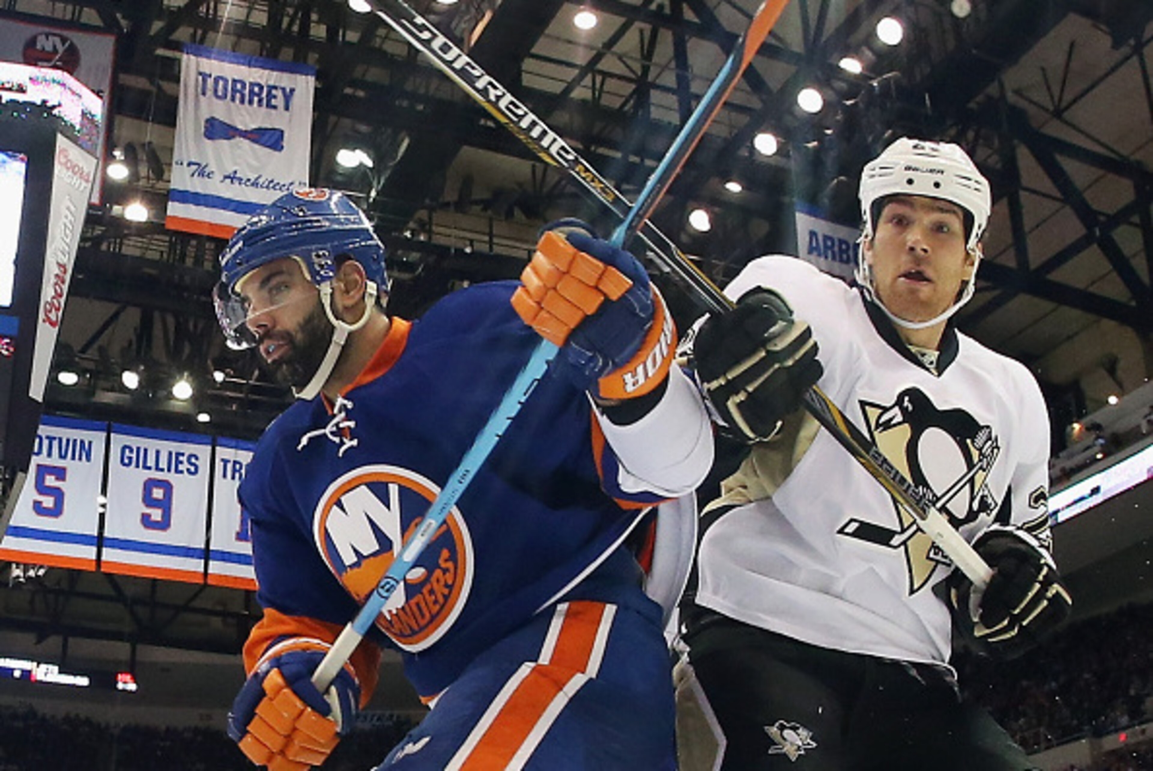 UNIONDALE, NY - JANUARY 16:  Steve Downie #23 of the Pittsburgh Penguins skates against Brian Strait #37 of the New York Islanders at the Nassau Veterans Memorial Coliseum on January 16, 2015 in Uniondale, New York.  (Photo by Bruce Bennett/Getty Images)