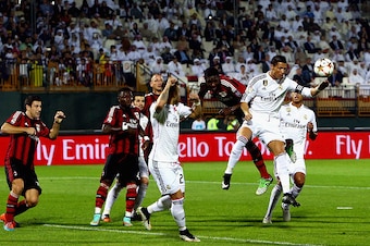 DUBAI, UNITED ARAB EMIRATES - DECEMBER 30: Christiano Ronaldo of Real Madrid compete for the ball with Christian Zapata of AC Milan  during the Dubai Football Challenge match between AC Milan and Real Madrid at The Sevens Stadium  on December 30, 2014 in 